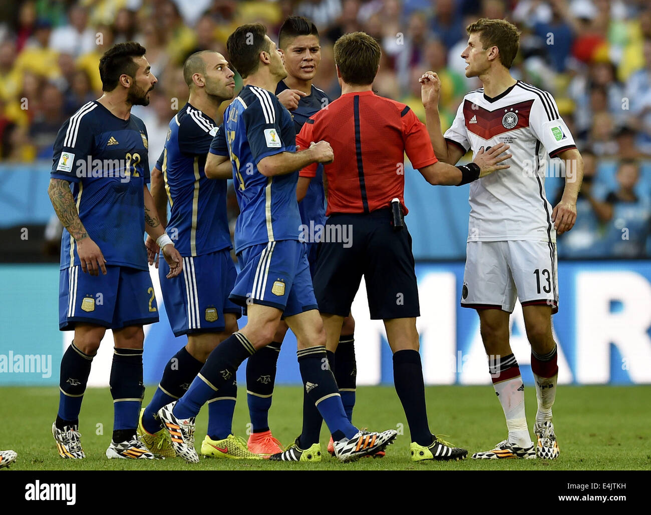 Rio De Janeiro, Brazil. 13th July, 2014. Italy's referee Nicola Rizzoli (2nd R) interrupts an arguement between Germany's Thomas Muller (1st R) and Argentina's players during the final match between Germany and Argentina of 2014 FIFA World Cup at the Estadio do Maracana Stadium in Rio de Janeiro, Brazil, on July 13, 2014. Credit:  Qi Heng/Xinhua/Alamy Live News Stock Photo