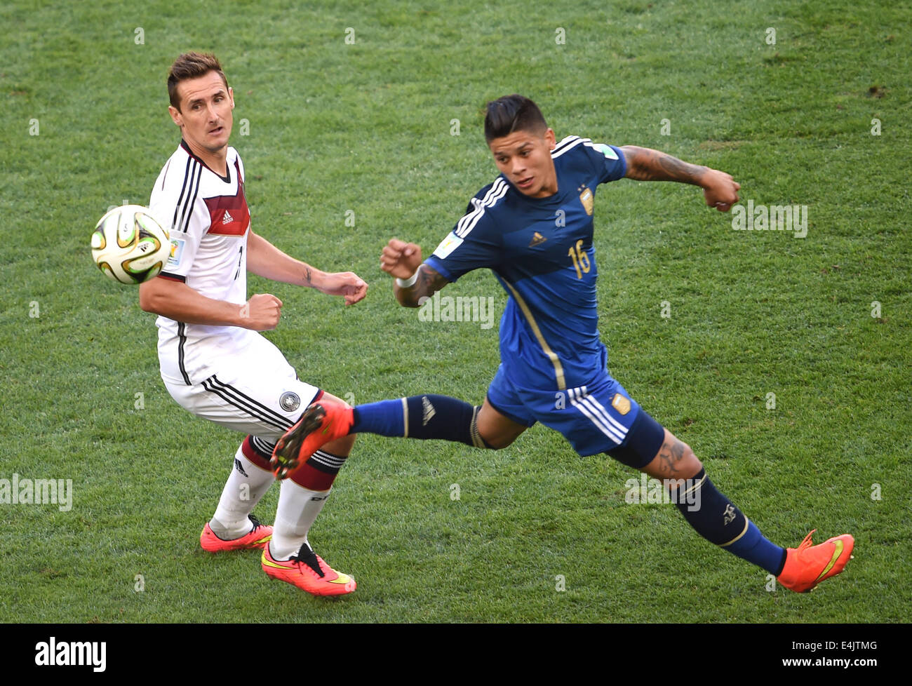 Rio De Janeiro, Brazil. 13th July, 2014. Germany's Miroslav Klose vies with Argentina's Marcos Rojo during the final match between Germany and Argentina of 2014 FIFA World Cup at the Estadio do Maracana Stadium in Rio de Janeiro, Brazil, on July 13, 2014. Credit:  Li Ga/Xinhua/Alamy Live News Stock Photo