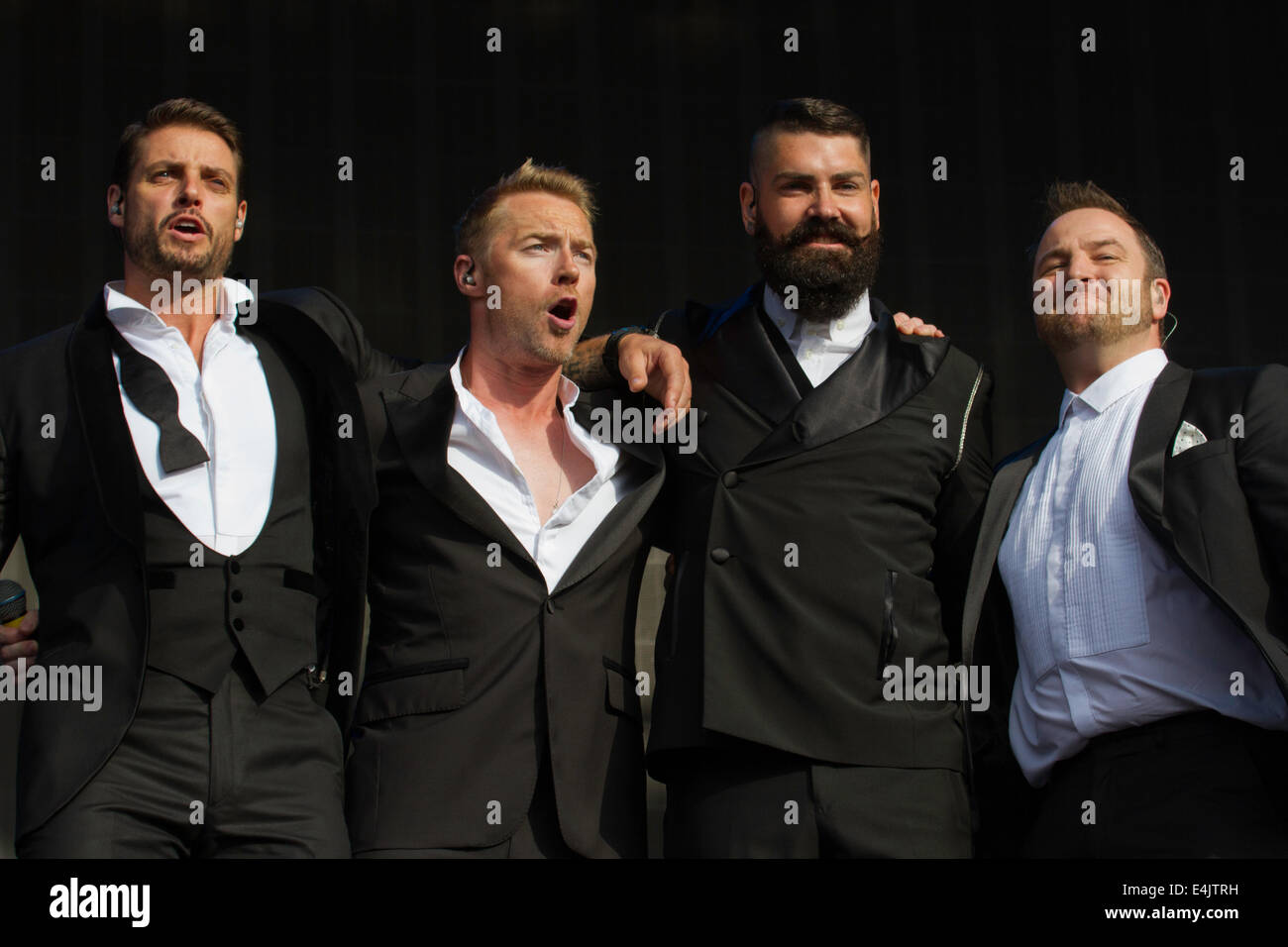 LONDON, ENGLAND - JULY 13: (l-r) Keith Duffy, Ronan Keating, Shane Lynch and Mikey Graham of Boyzone perform on stage at British Stock Photo
