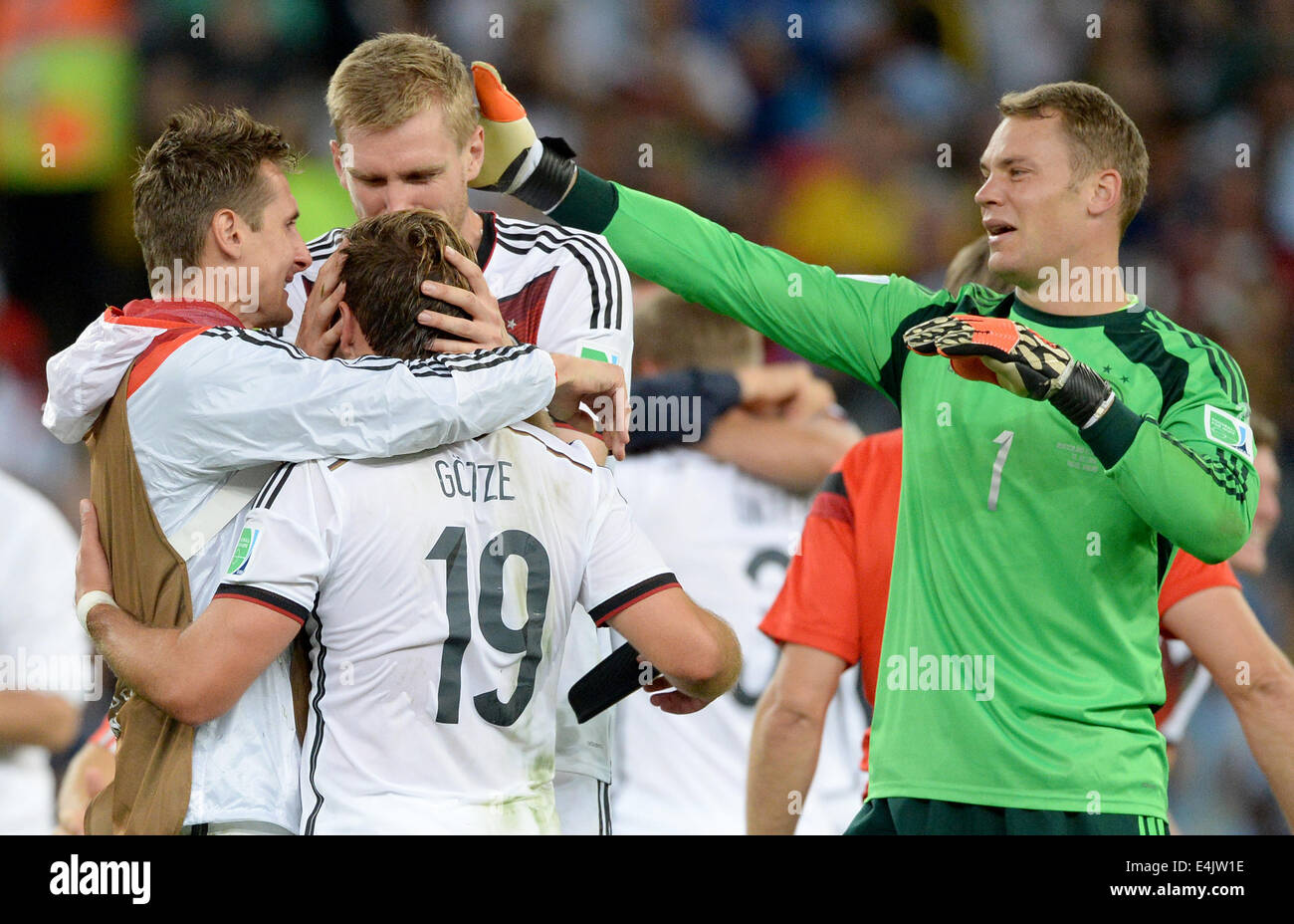 Rio de Janeiro, Brazil. 13th July, 2014. Miroslav Klose (L-R), Mario Goetze, Per Mertesacker and goalkeeper Manuel Neuer of Germany celebrate after winning the FIFA World Cup 2014 final soccer match between Germany and Argentina at the Estadio do Maracana in Rio de Janeiro, Brazil, 13 July 2014. Photo: Marcus Brandt/dpa/Alamy Live News Stock Photo