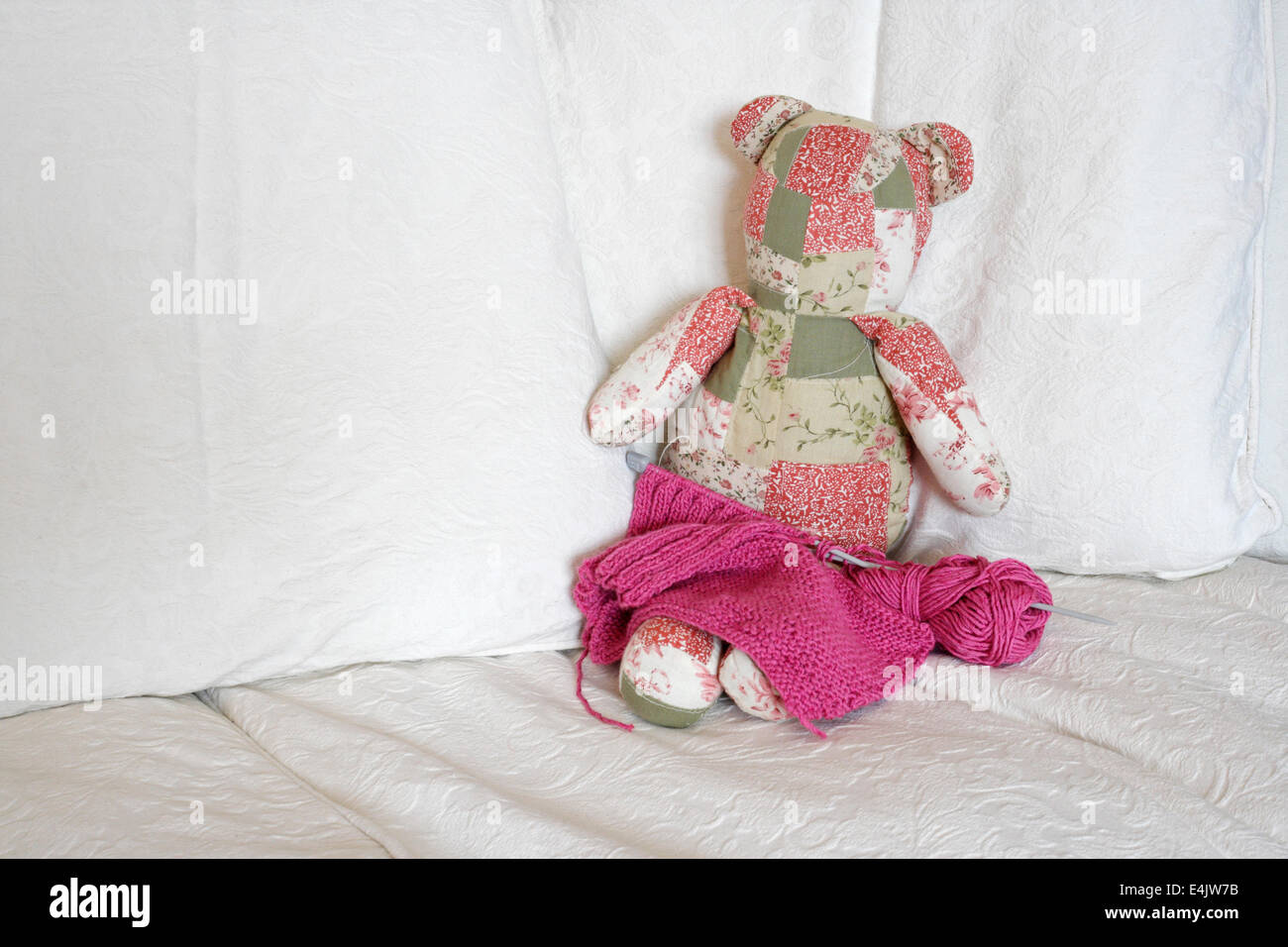 Child friendly fabric teddy bear cuddly toy on a settee Stock Photo