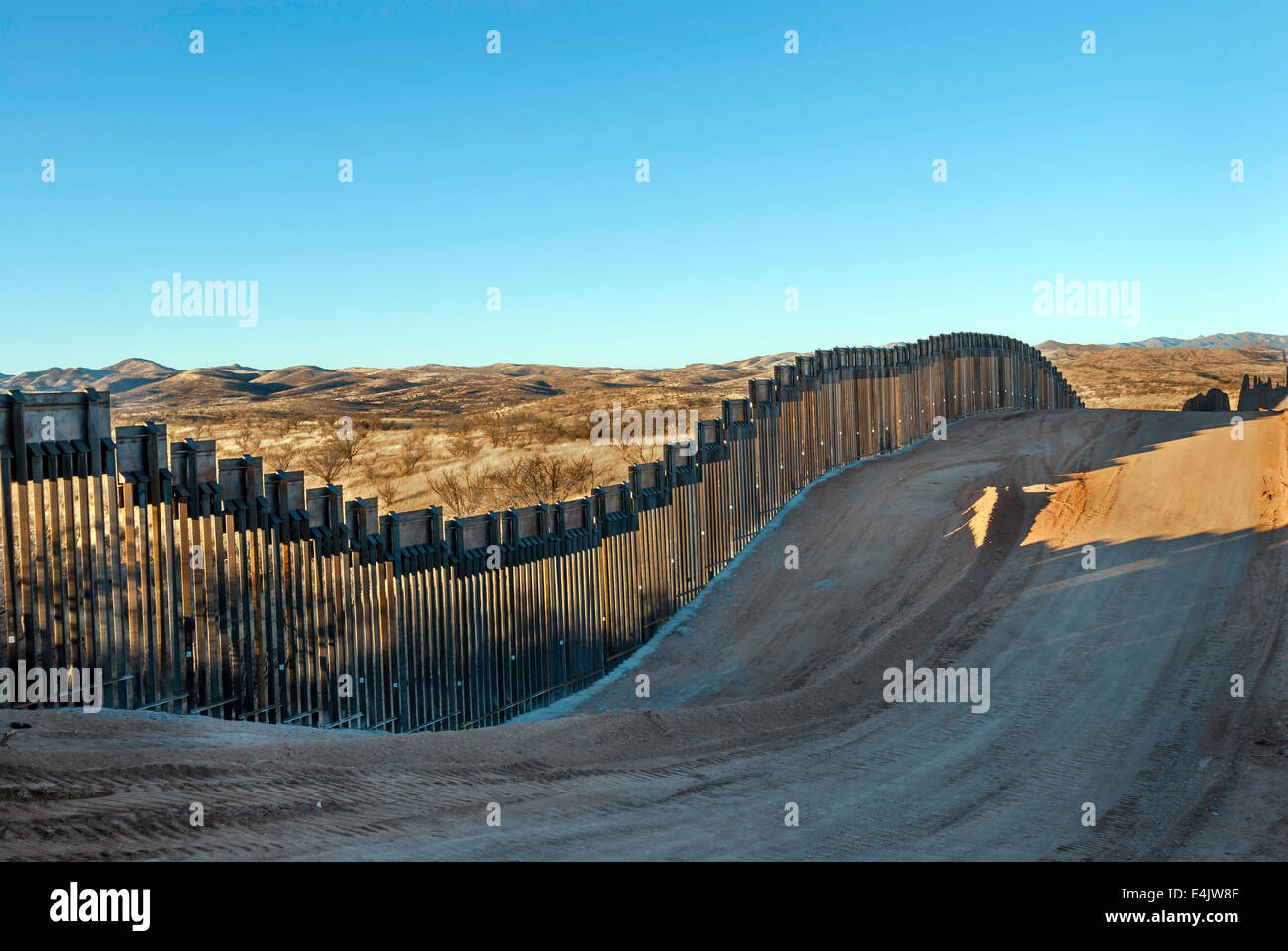 Massive US Border fence, about seven miles east of Nogales Arizona USA, viewed from US side Stock Photo