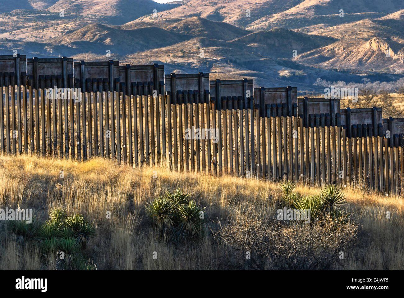Massive 16 foot tall US border fence on border with Mexico, about 6 miles east of Nogales Arizona, USA, looking south to Mexico Stock Photo