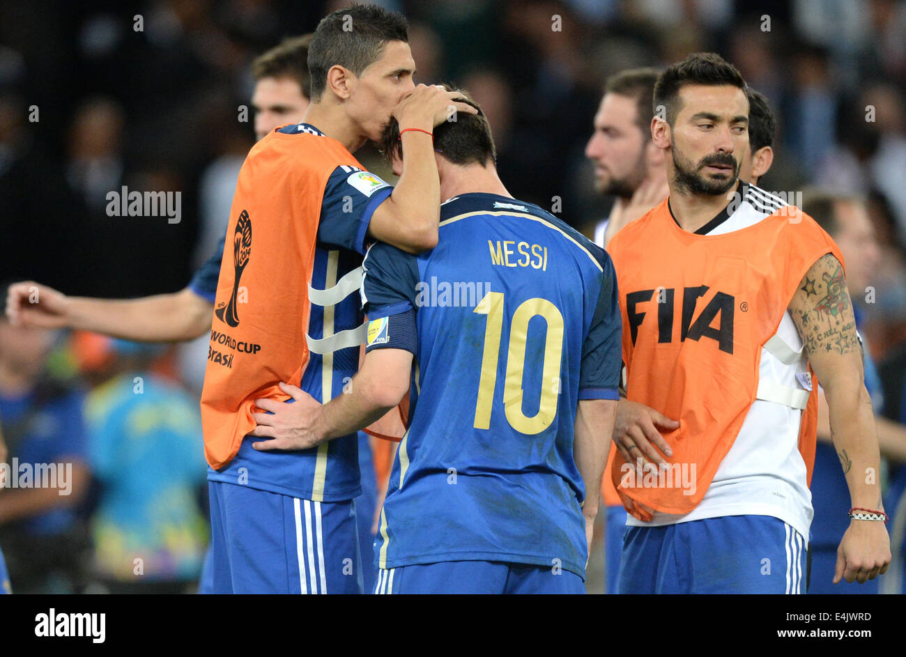 Rio de Janeiro, Brazil. 13th July, 2014. Lionel Messi (C) of Argentina looks dejected next to Ezequiel Lavezzi (R) after the FIFA World Cup 2014 final soccer match between Germany and Argentina at the Estadio do Maracana in Rio de Janeiro, Brazil, 13 July 2014. Photo: Marcus Brandt/dpa/Alamy Live News Stock Photo