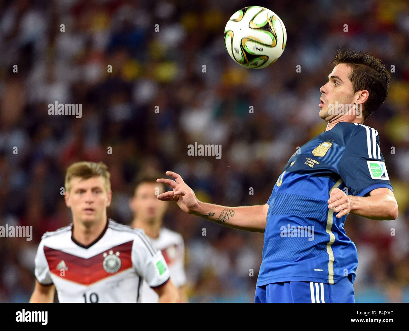 Rio De Janeiro, Brazil. 13th July, 2014. Argentina's Fernando Gago (R) controls the ball during the final match between Germany and Argentina of 2014 FIFA World Cup at the Estadio do Maracana Stadium in Rio de Janeiro, Brazil, on July 13, 2014. Germany won 1-0 over Argentina after 120 minutes and took its fourth World Cup title on Sunday. Credit:  Liu Dawei/Xinhua/Alamy Live News Stock Photo