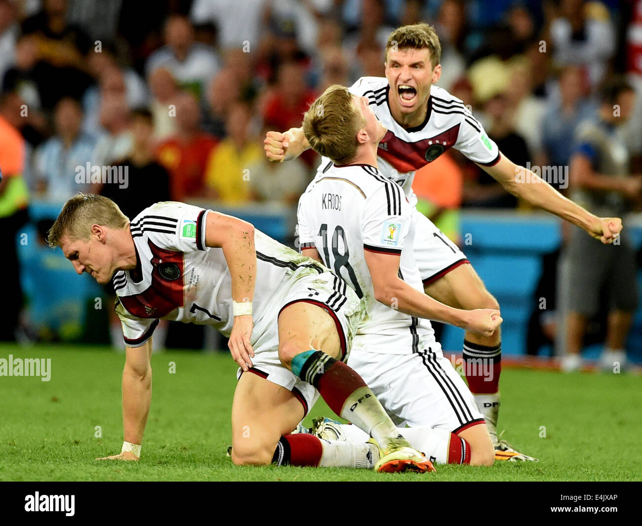 Rio De Janeiro, Brazil. 13th July, 2014. Germany's Thomas Muller, Toni Kroos and Bastian Schweinsteiger (R to L) celebrate their victory after the final match between Germany and Argentina of 2014 FIFA World Cup at the Estadio do Maracana Stadium in Rio de Janeiro, Brazil, on July 13, 2014. Germany won 1-0 over Argentina after 120 minutes and took its fourth World Cup title on Sunday. Credit:  Liu Dawei/Xinhua/Alamy Live News Stock Photo