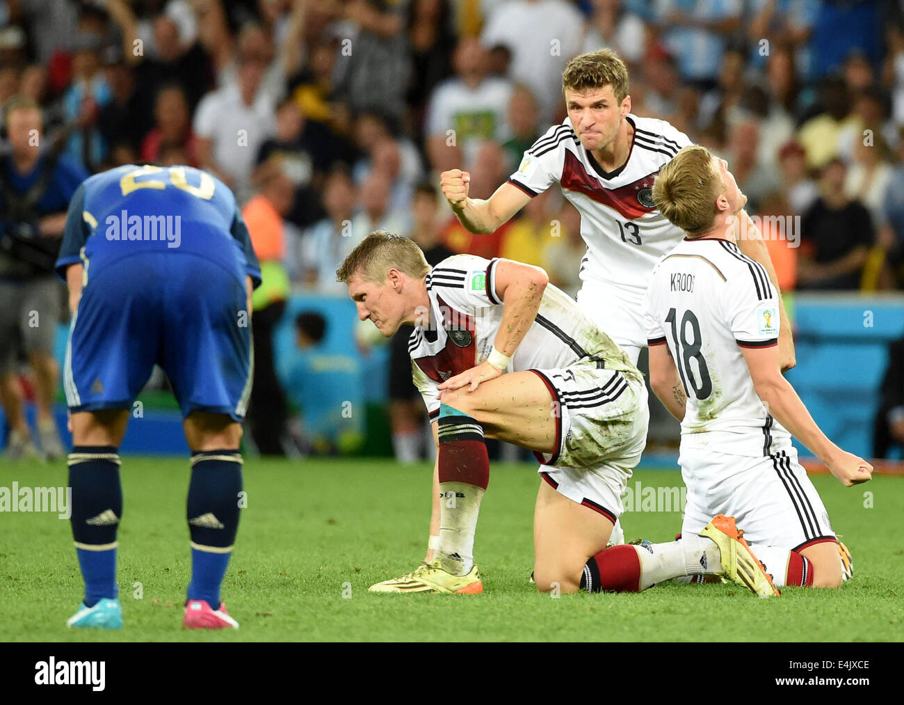 Rio De Janeiro, Brazil. 13th July, 2014. Germany's Toni Kroos, Thomas Muller and Bastian Schweinsteiger (1st R to 3rd R) celebrate their victory after the final match between Germany and Argentina of 2014 FIFA World Cup at the Estadio do Maracana Stadium in Rio de Janeiro, Brazil, on July 13, 2014. Germany won 1-0 over Argentina after 120 minutes and took its fourth World Cup title on Sunday. Credit:  Liu Dawei/Xinhua/Alamy Live News Stock Photo