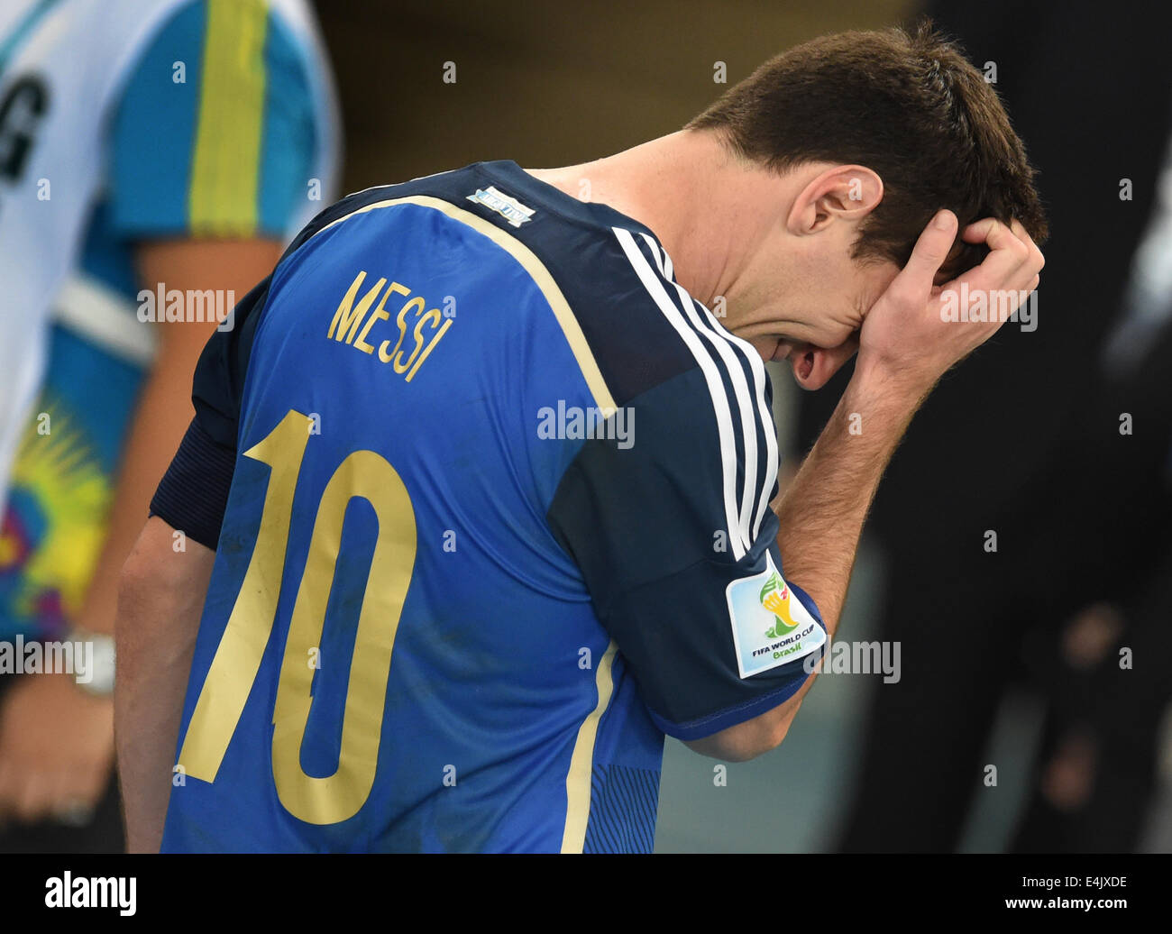 Rio de Janeiro, Brazil. 13th July, 2014. Argentina's Lionel Messi walks dejected over the pitch after losing the FIFA World Cup 2014 final between Germany and Argentina at the Estadio do Maracana in Rio de Janeiro, Brazil, 13 July 2014. Photo: Andreas Gebert/dpa/Alamy Live News Stock Photo