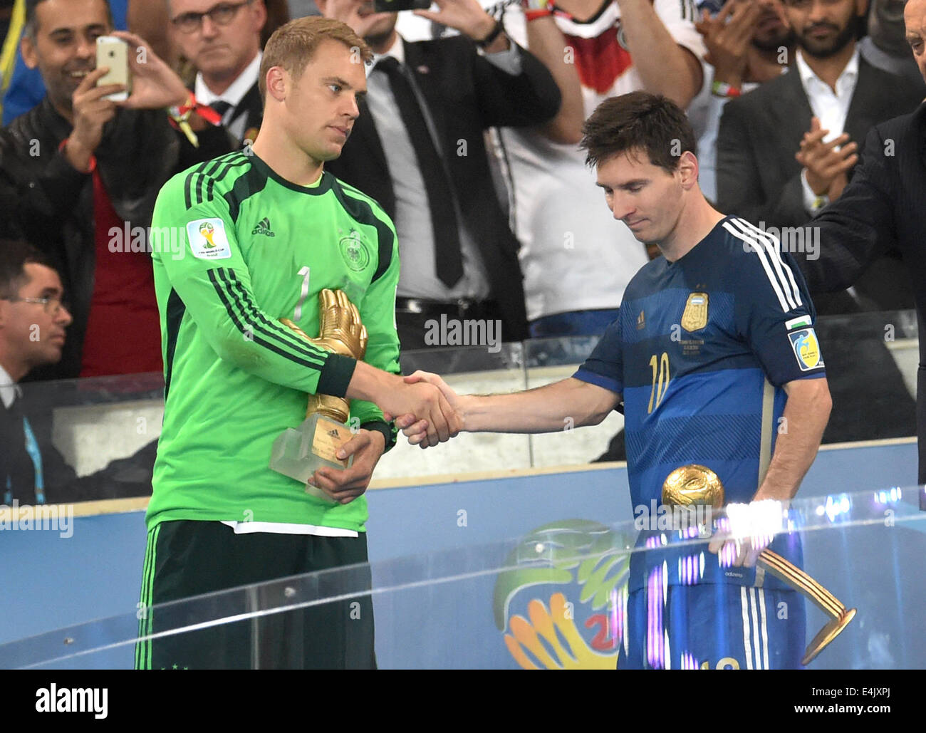 Rio de Janeiro, Brazil. 13th July, 2014. Goalkeeper Manuel Neuer of Germany (L) and Lionel Messi of Argentina shakes hand after being awarded as best goalkeeper with the golden glove and the best player with the golden ball after the FIFA World Cup 2014 final between Germany and Argentina at the Estadio do Maracana in Rio de Janeiro, Brazil, 13 July 2014. Photo: Andreas Gebert/dpa/Alamy Live News Stock Photo