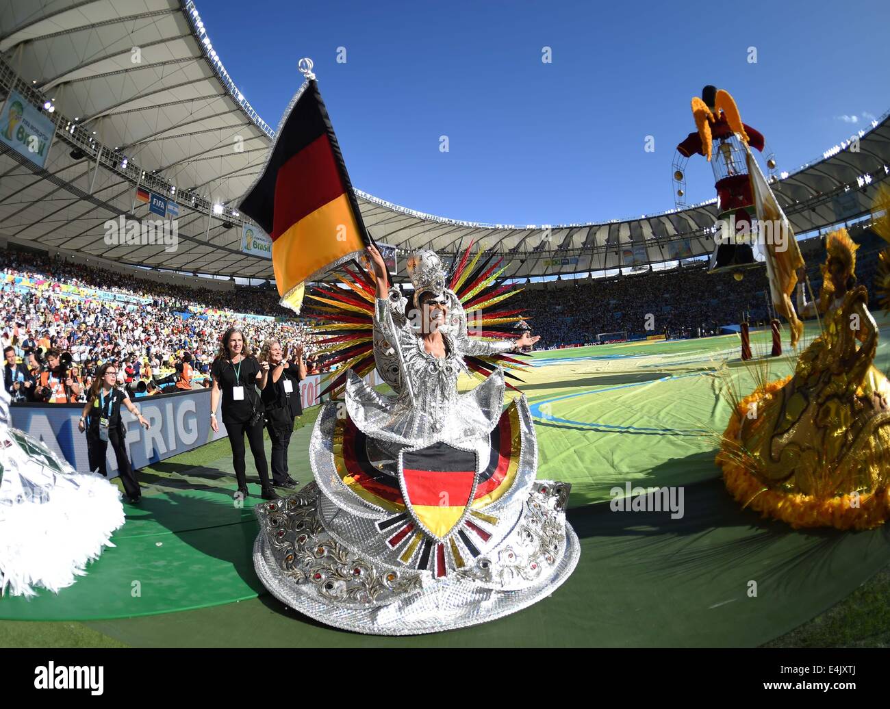 Rio De Janeiro, Brazil. 13th July, 2014. A dancer carries a Germany's national flag during the closing ceremony before the final match between Germany and Argentina of 2014 FIFA World Cup at the Estadio do Maracana Stadium in Rio de Janeiro, Brazil, on July 13, 2014. Credit:  Liu Dawei/Xinhua/Alamy Live News Stock Photo