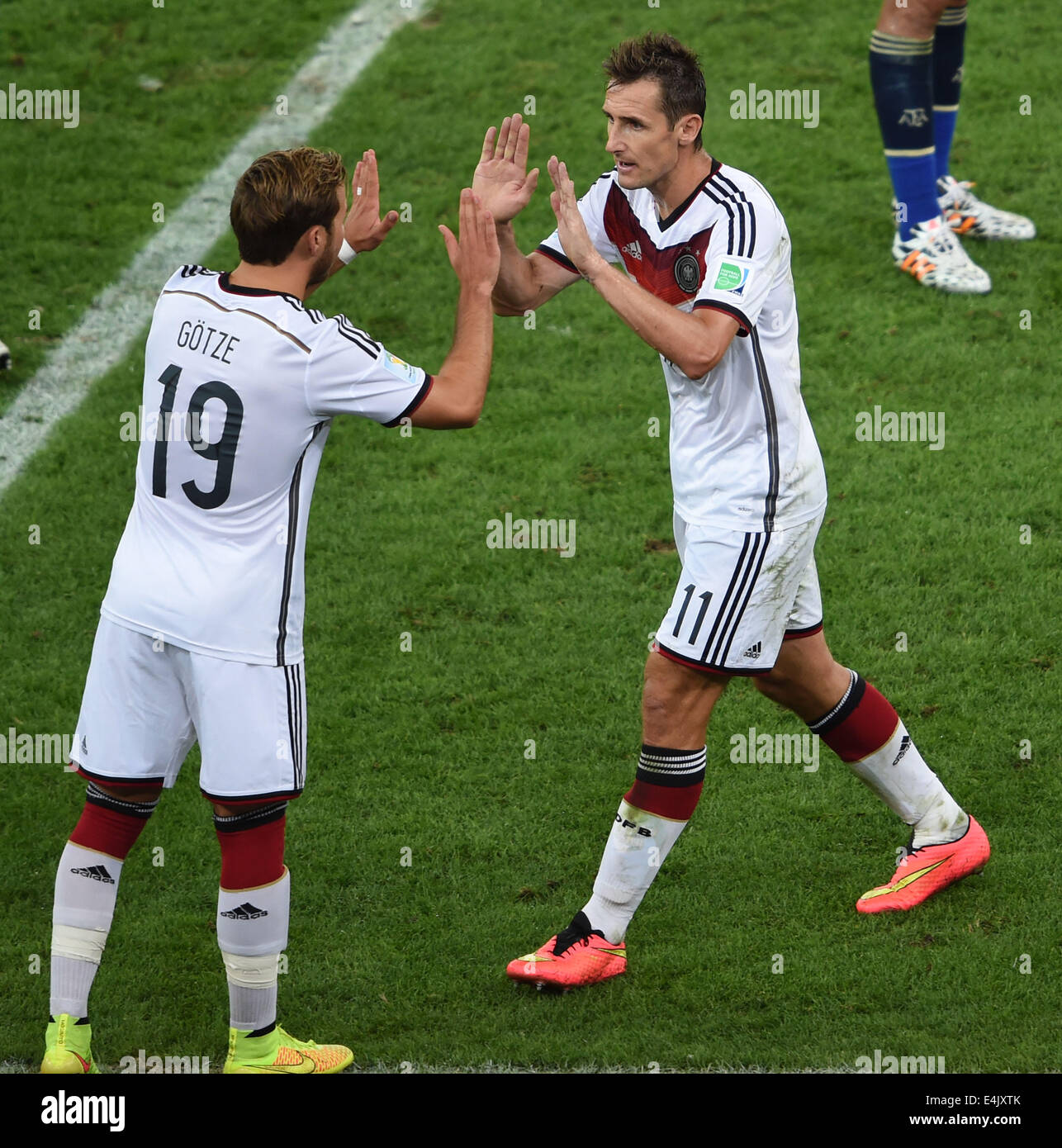 Rio De Janeiro, Brazil. 13th July, 2014. Germany's Miroslav Klose (R) is substituted by Mario Gotze (L) during the final match between Germany and Argentina of 2014 FIFA World Cup at the Estadio do Maracana Stadium in Rio de Janeiro, Brazil, on July 13, 2014. Credit:  Li Ga/Xinhua/Alamy Live News Stock Photo