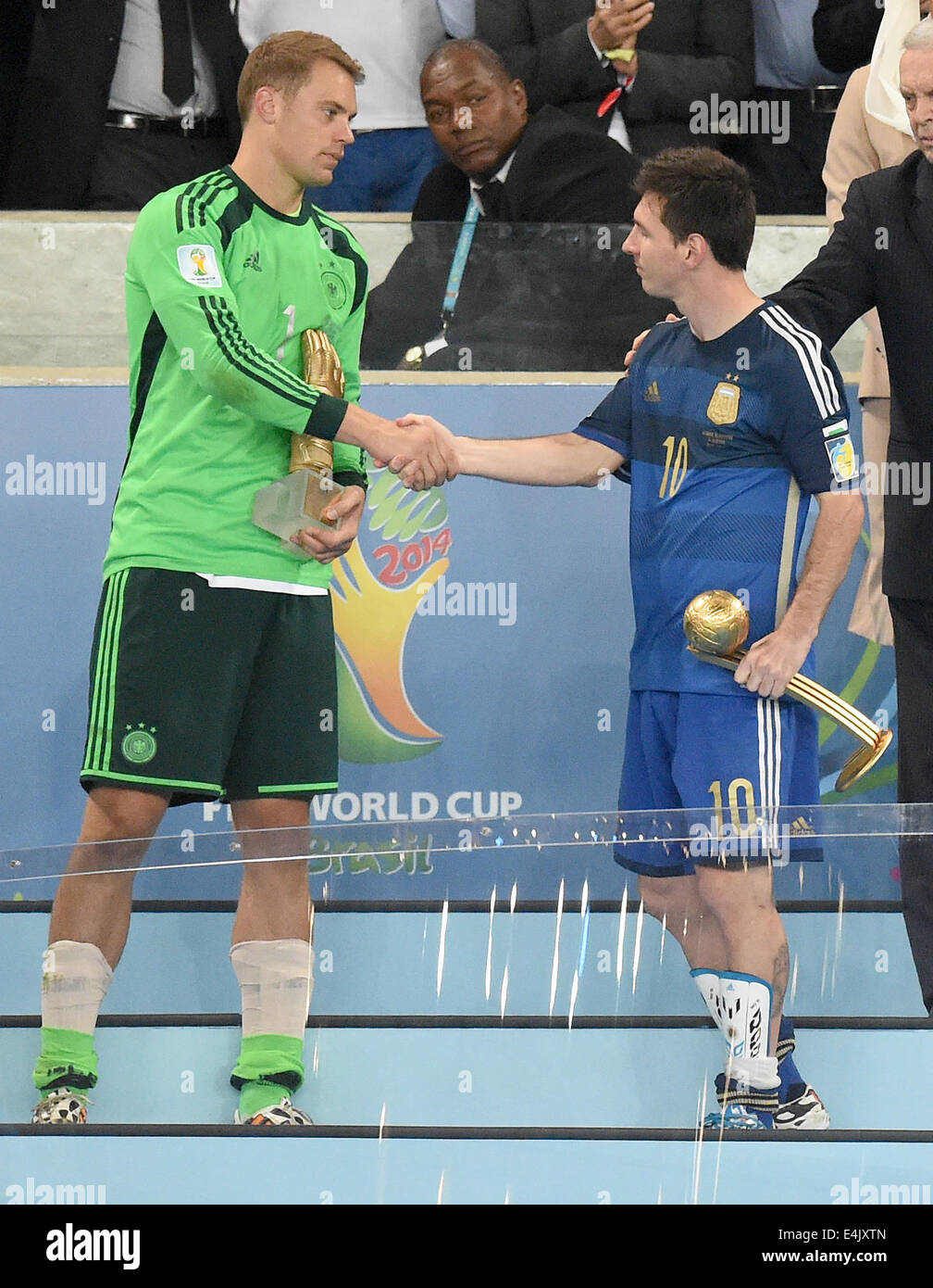Rio de Janeiro, Brazil. 13th July, 2014. Goalkeeper Manuel Neuer of Germany (L) and Lionel Messi of Argentina shakes hand after being awarded as best goalkeeper with the golden glove and the best player with the golden ball after the FIFA World Cup 2014 final between Germany and Argentina at the Estadio do Maracana in Rio de Janeiro, Brazil, 13 July 2014. Photo: Marcus Brandt/dpa/Alamy Live News Stock Photo