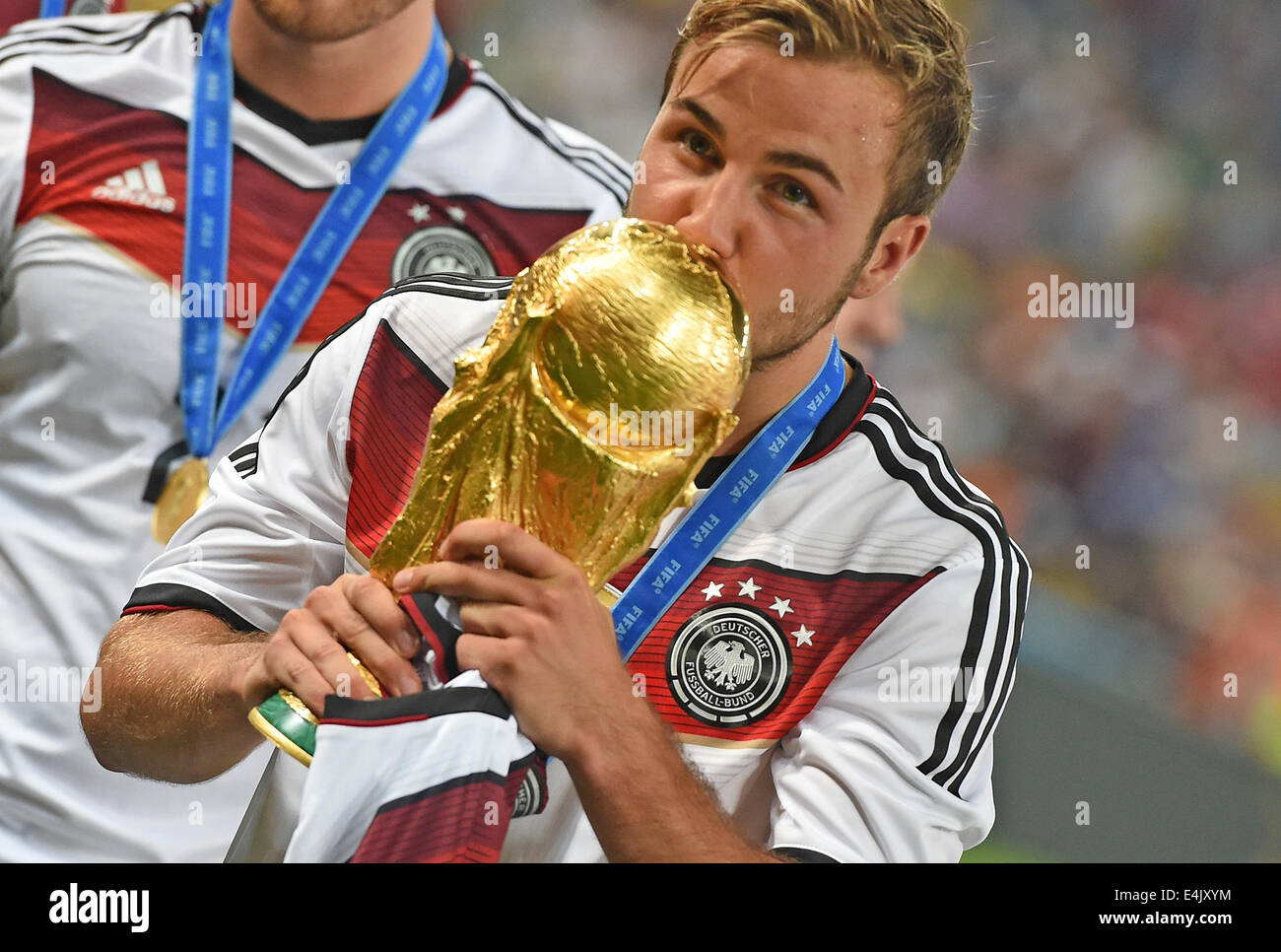 Rio de Janeiro, Brazil. 13th July, 2014. Mario Goetze of Germany kisses the World Cup trophy after winning the FIFA World Cup 2014 final soccer match between Germany and Argentina at the Estadio do Maracana in Rio de Janeiro, Brazil, 13 July 2014. Photo: Marcus Brandtt/dpa/Alamy Live News Stock Photo