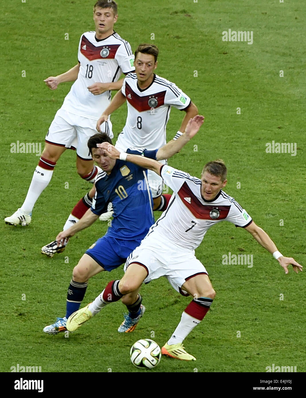 Rio De Janeiro, Brazil. 13th July, 2014. Germany's Toni Kroos (No.18), Mesut Ozil (No.8) and Bastian Schweinsteiger (No.7) vie for the ball with Argentina's Lionel Messi during the final match between Germany and Argentina of 2014 FIFA World Cup at the Estadio do Maracana Stadium in Rio de Janeiro, Brazil, on July 13, 2014. Credit:  Lui Siu Wai/Xinhua/Alamy Live News Stock Photo