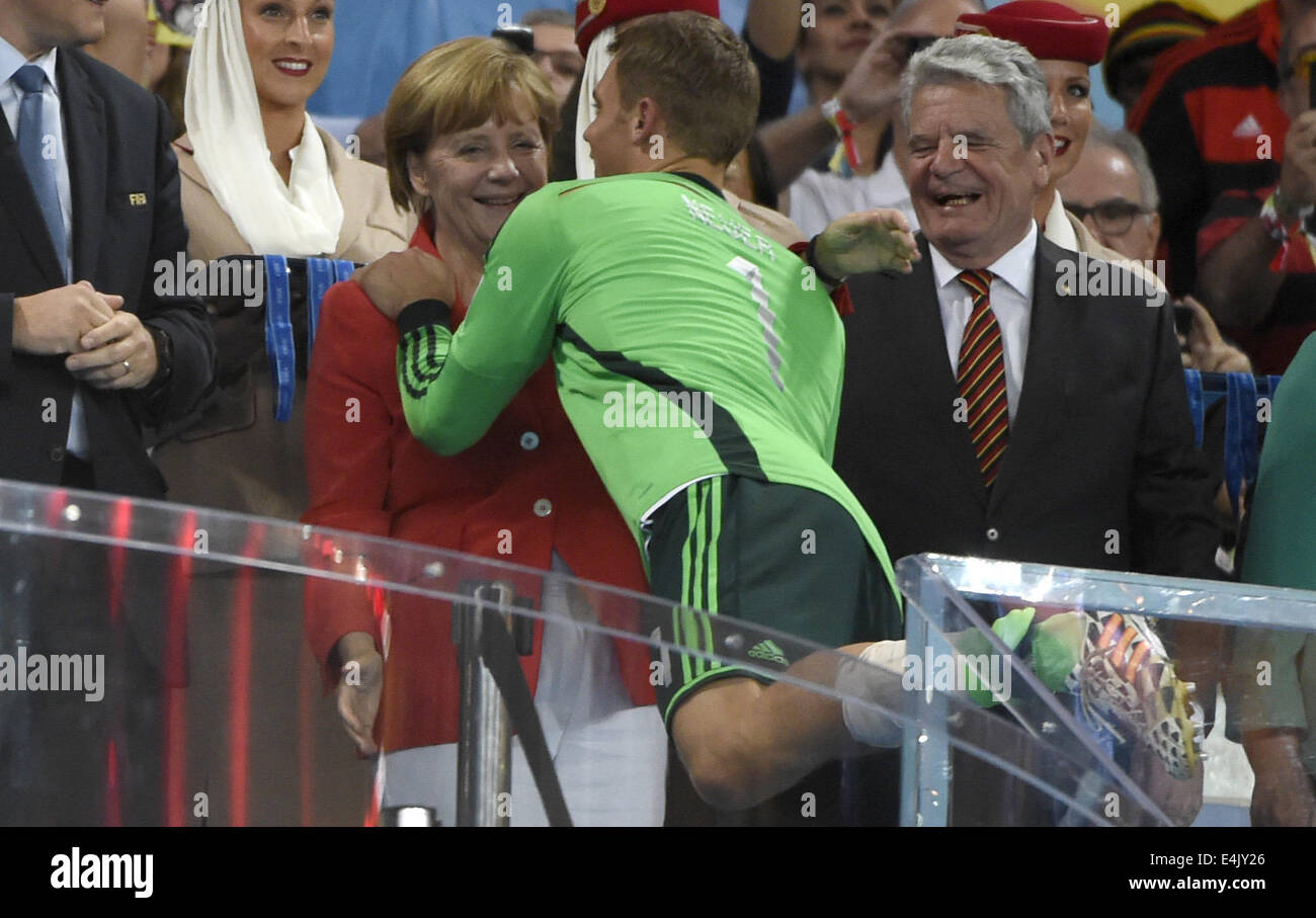 Rio De Janeiro, Brazil. 13th July, 2014. Germany's goalkeeper Manuel Neuer (C) embraces German Chancellor Angela Merkel (L) after the final match between Germany and Argentina of 2014 FIFA World Cup at the Estadio do Maracana Stadium in Rio de Janeiro, Brazil, on July 13, 2014. Germany won 1-0 over Argentina after 120 minutes and took its fourth World Cup title on Sunday. Credit:  Yang Lei/Xinhua/Alamy Live News Stock Photo