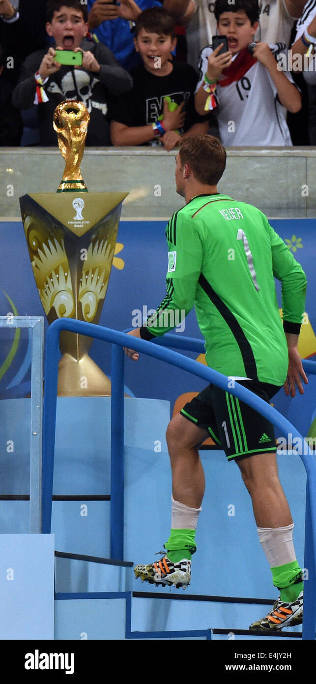 Rio de Janeiro, Brazil. 13th July, 2014. Goalkeeper Manuel Neuer of Germany walks up in the stands to the World Cup trophy after winning the the FIFA World Cup 2014 final soccer match between Germany and Argentina at the Estadio do Maracana in Rio de Janeiro, Brazil, 13 July 2014. Photo: Marcus Brandt/dpa/Alamy Live News Stock Photo