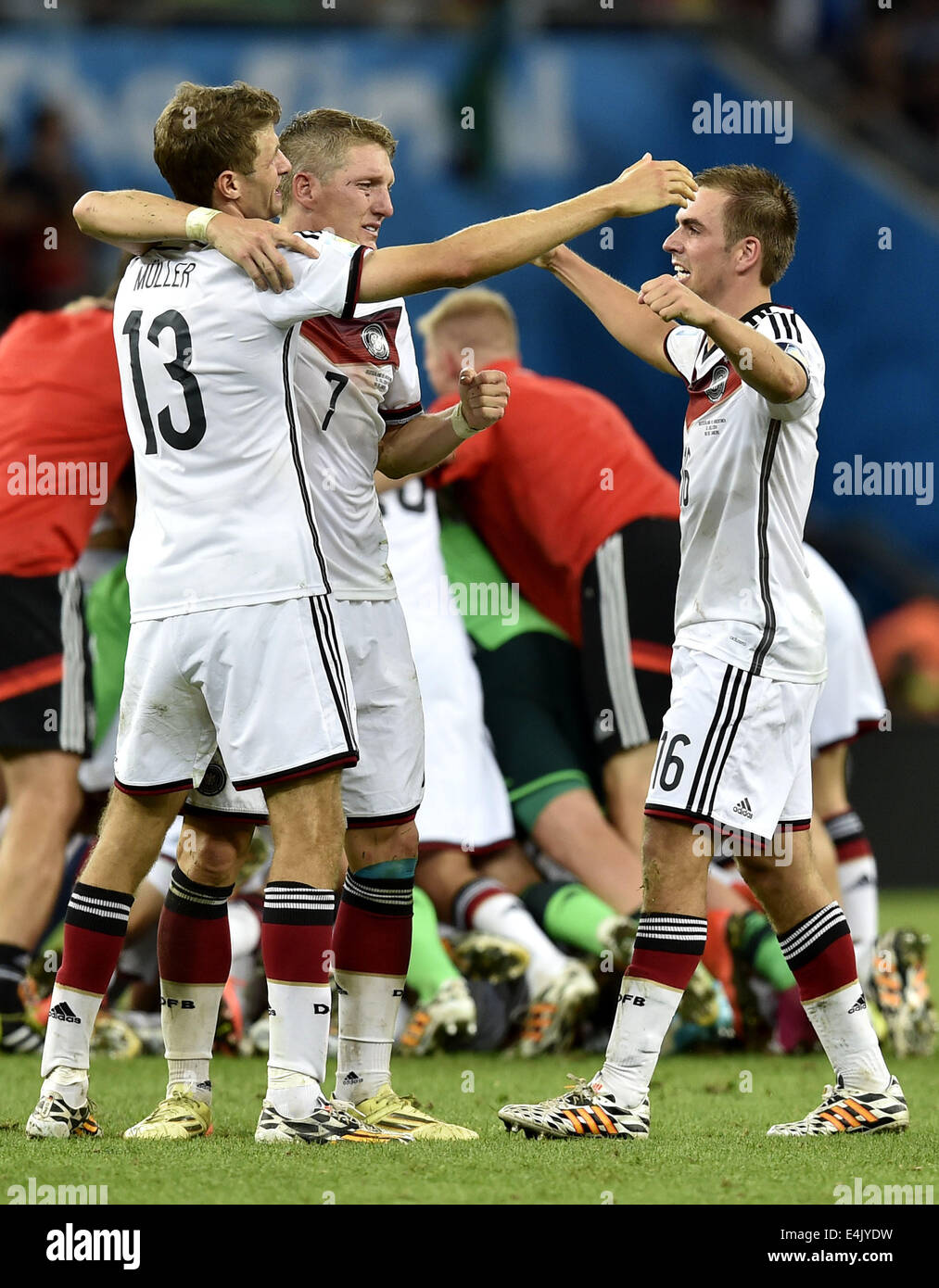 Rio De Janeiro, Brazil. 13th July, 2014. Germany's Thomas Muller (L), Bastian Schweinsteiger (C) and Philipp Lahm celebrate their victory after the final match between Germany and Argentina of 2014 FIFA World Cup at the Estadio do Maracana Stadium in Rio de Janeiro, Brazil, on July 13, 2014. Germany won 1-0 over Argentina after 120 minutes and took its fourth World Cup title on Sunday. Credit:  Qi Heng/Xinhua/Alamy Live News Stock Photo