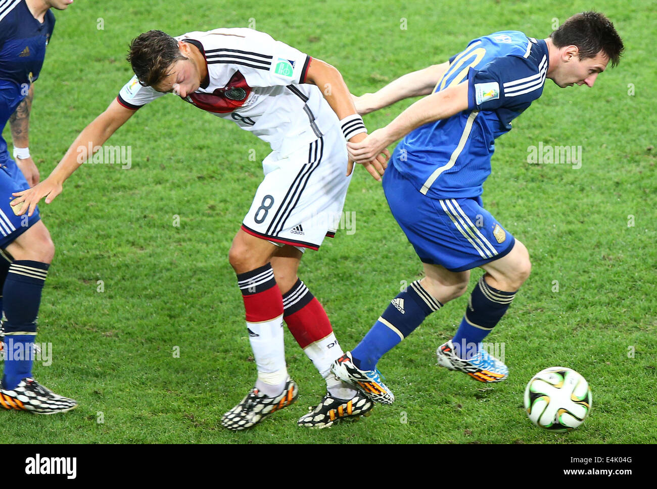 Rio De Janeiro, Brazil. 13th July, 2014. Germany's Mesut Ozil vies with Argentina's Lionel Messi during the final match between Germany and Argentina of 2014 FIFA World Cup at the Estadio do Maracana Stadium in Rio de Janeiro, Brazil, on July 13, 2014. Credit:  Chen Jianli/Xinhua/Alamy Live News Stock Photo
