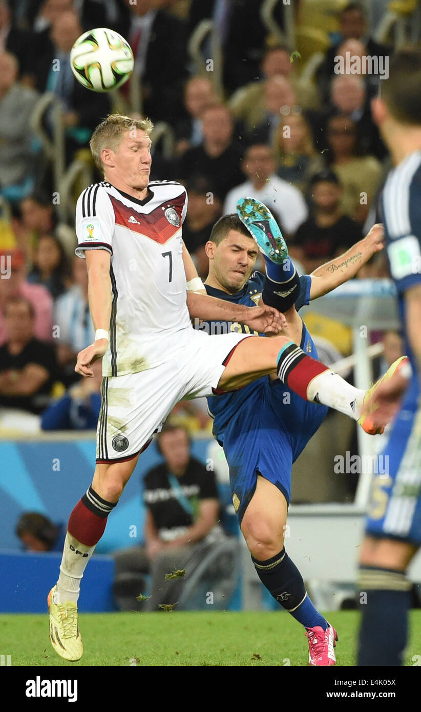 Rio De Janeiro, Brazil. 13th July, 2014. Germany's Bastian Schweinsteiger (L) vies with Argentina's Sergio Aguero during the final match between Germany and Argentina of 2014 FIFA World Cup at the Estadio do Maracana Stadium in Rio de Janeiro, Brazil, on July 13, 2014. Credit:  Liu Dawei/Xinhua/Alamy Live News Stock Photo