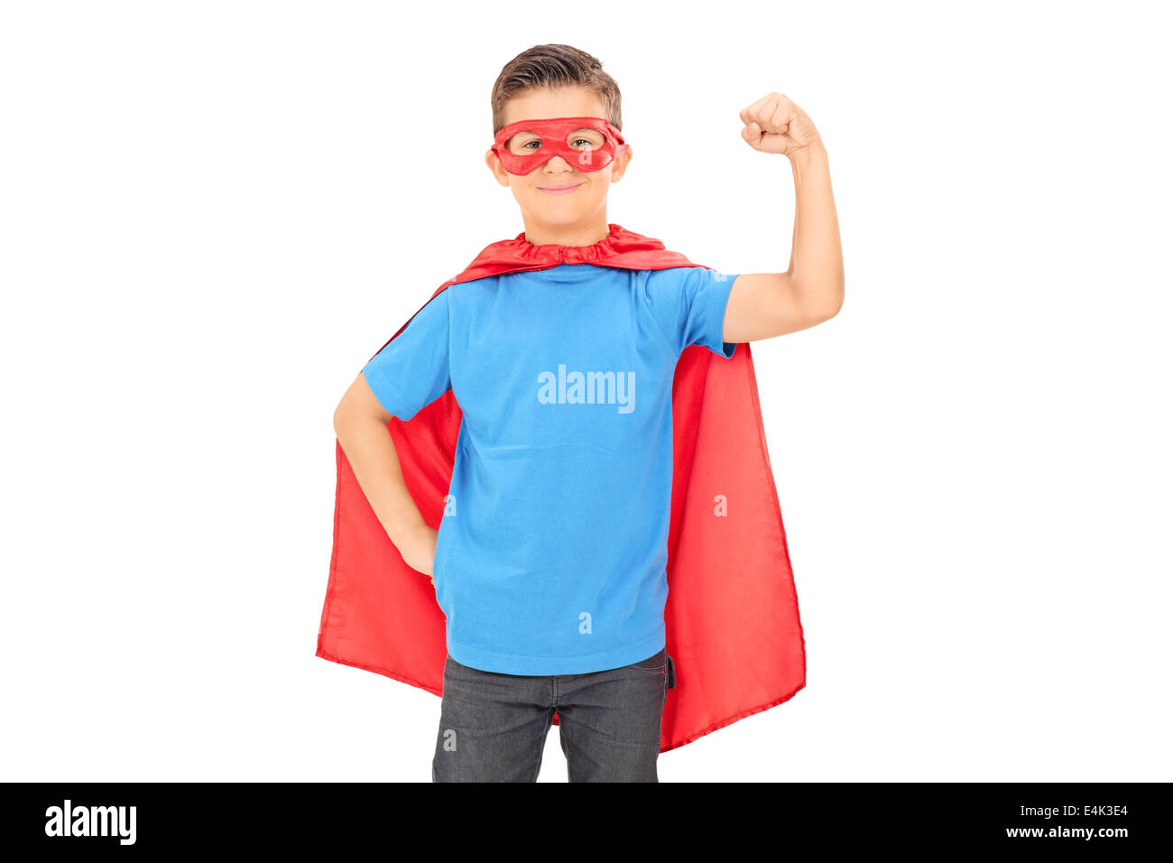 Junior superhero holding his fist in the air Stock Photo