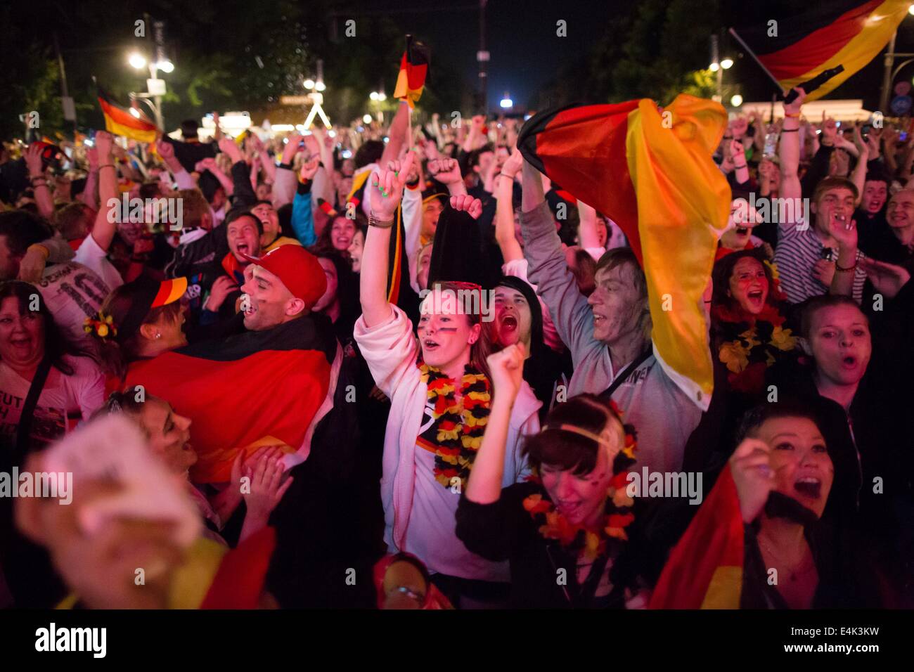 Berlin, Germany. 13th July, 2014. Spectators cheer during the FIFA World Cup 2014 Final match between Germany and Argentina in the fan mile at the Brandenburg Gate in Berlin, Germany, 13 July 2014. Germany won 1-0 and became World Champion. Photo: Maja Hitij/dpa/Alamy Live News Stock Photo