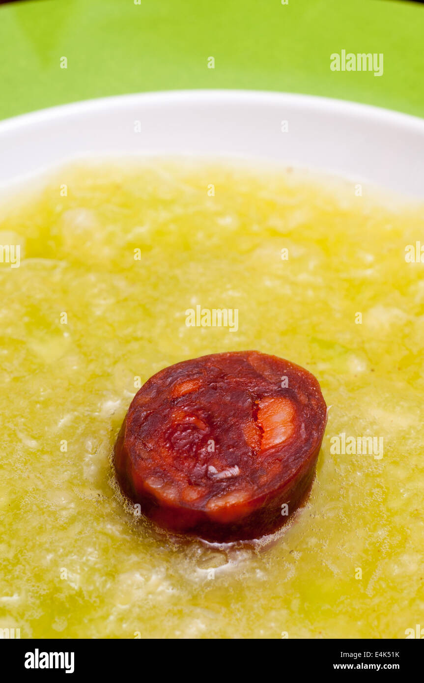 Hot pork sausage chorizo in cold melon soup Stock Photo