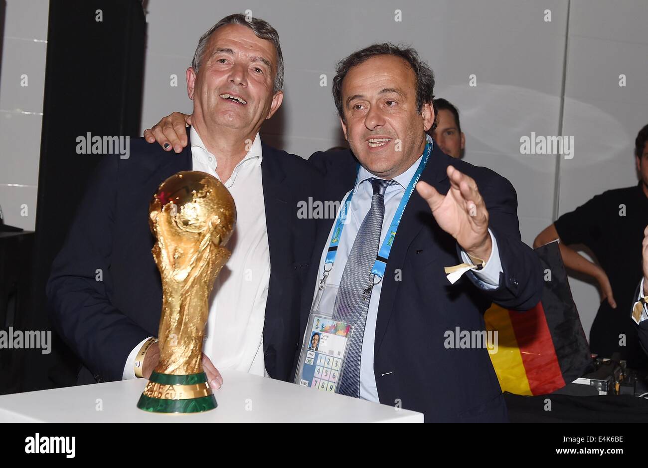 Handout: Rio de Janeiro, Brazil. 14th July, 2014. UEFA President Michel Platini (R) congratulating DFB President Wolfgang Niersbach after Germany's victory in the Soccer World Cup with the trophy at Hotel Sheraton in Rio De Janeiro, Brazil on 13 July 2014. Germany won 1-0 against Argentina in the FIFA World Cup 2014 Final match. (: Image for in connection with the current reporting on the World Cup and together with the source: Photo: Markus Gilliar/DFB/dpa.) Credit:  dpa picture alliance/Alamy Live News Stock Photo