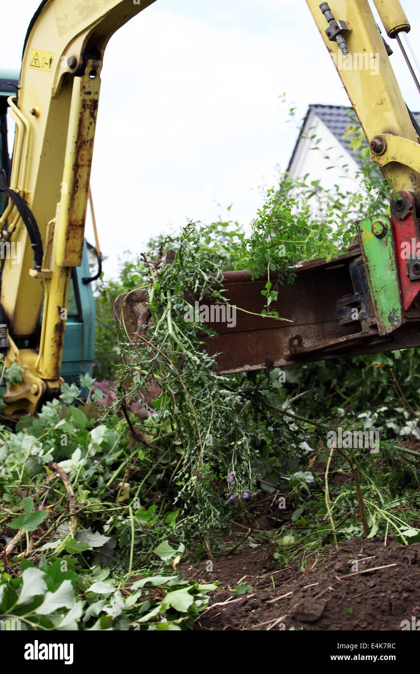 Mechanical digger clearing building plot Stock Photo - Alamy