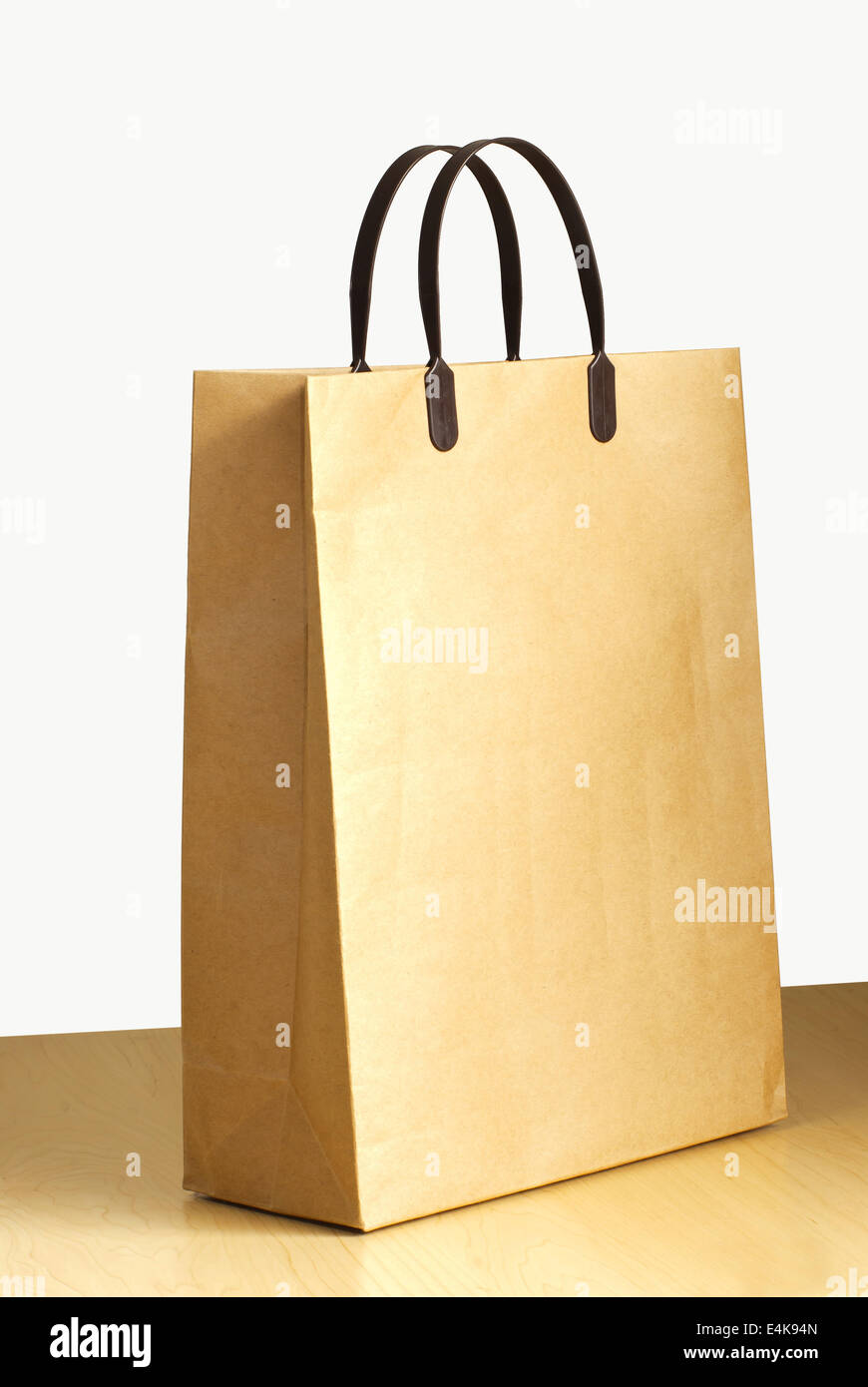 Paper bag on wooden floor Stock Photo - Alamy