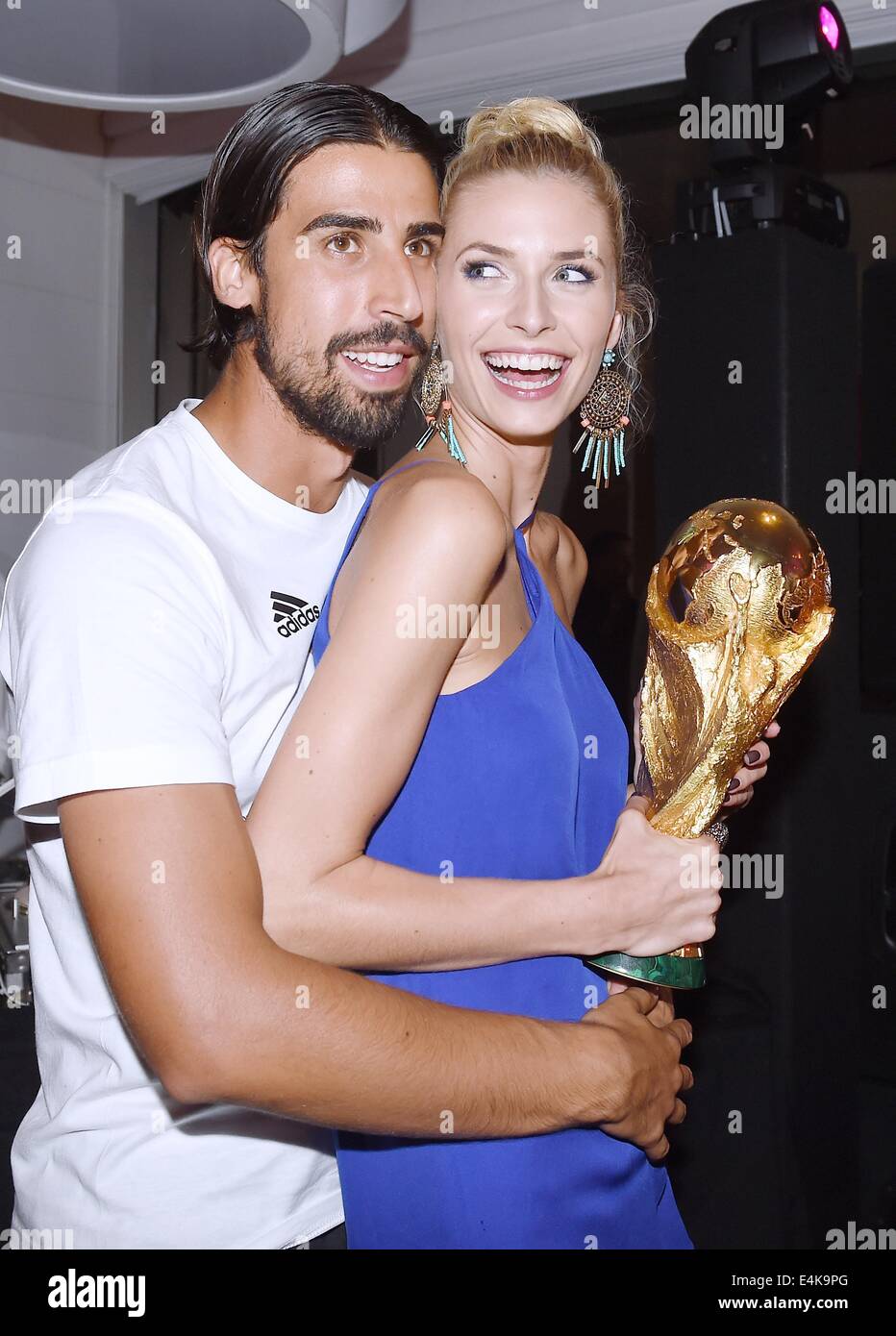 Handout: Rio de Janeiro, Brazil. 14th July, 2014. Sami Khedira and girlfriend Lena Gercke celebrating Germany's victory in the Soccer World Cup with the trophy at Hotel Sheraton in Rio De Janeiro, Brazil on 13 July 2014. Germany won 1-0 against Argentina in the FIFA World Cup 2014 Final match. (: Image for in connection with the current reporting on the World Cup and together with the source: Photo: Markus Gilliar/DFB/dpa.) Credit:  dpa picture alliance/Alamy Live News Stock Photo
