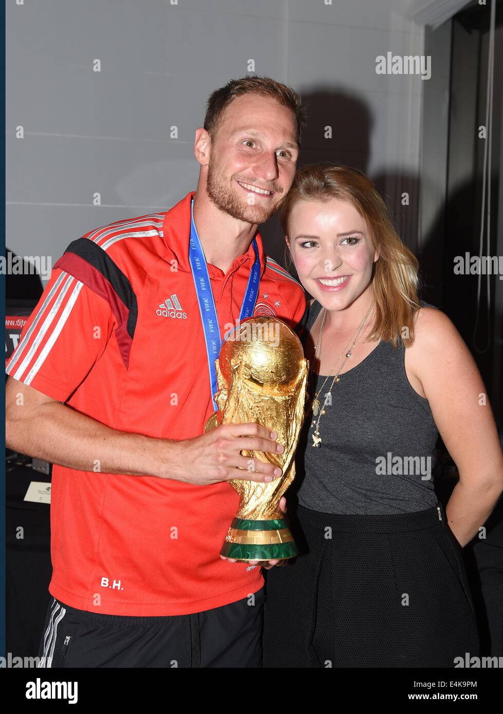Handout: Rio de Janeiro, Brazil. 14th July, 2014. Benedikt Hoewedes and his girlfriend Lisa Wesseler, celebrating Germany's victory in the Soccer World Cup with the trophy at Hotel Sheraton in Rio De Janeiro, Brazil on 13 July 2014. Germany won 1-0 against Argentina in the FIFA World Cup 2014 Final match. (: Image for in connection with the current reporting on the World Cup and together with the source: Photo: Markus Gilliar/DFB/dpa.) Credit:  dpa picture alliance/Alamy Live News Stock Photo