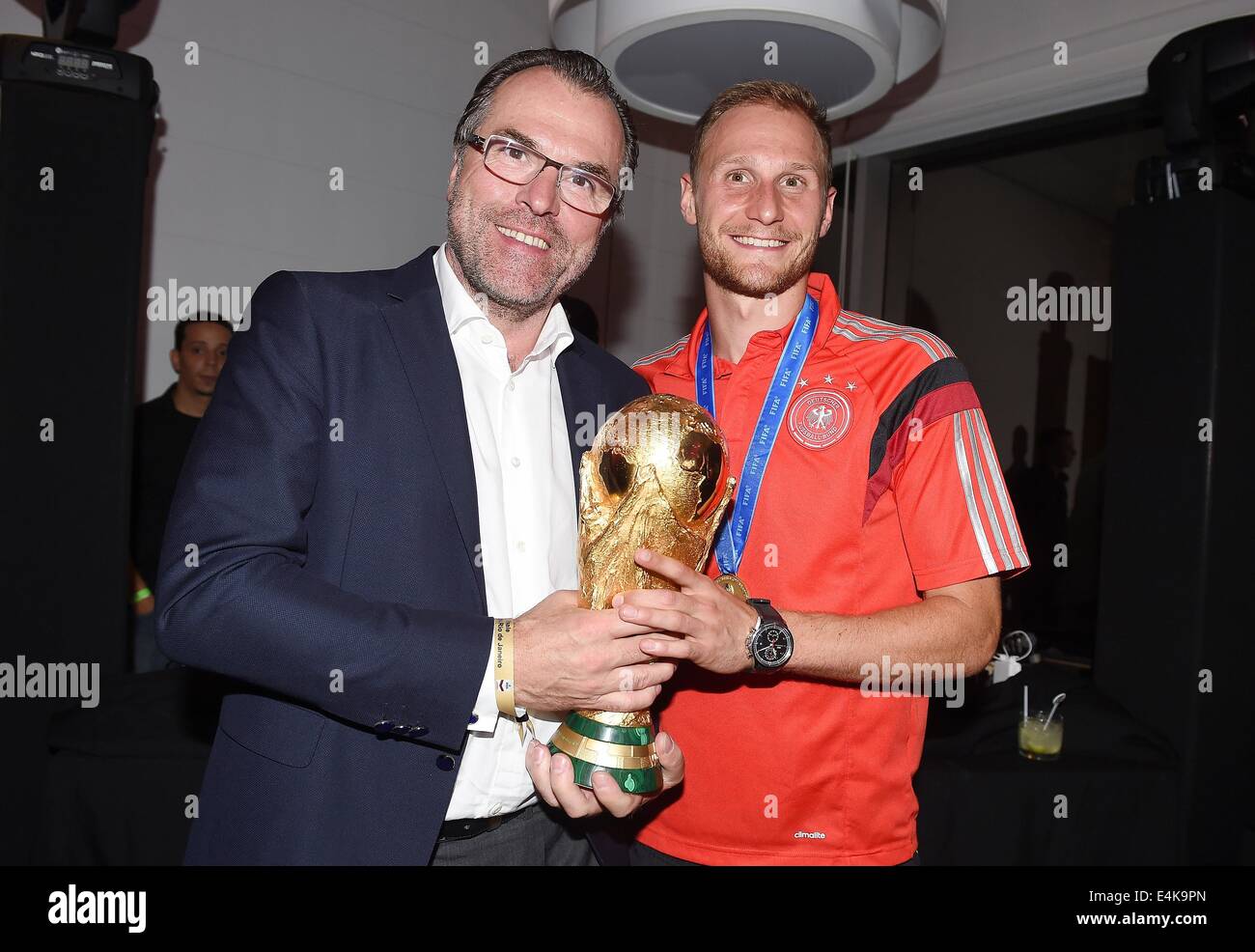 Handout: Rio de Janeiro, Brazil. 14th July, 2014. Benedikt Hoewedes (R) and the chairman of the supervisory board of FC Schalke 04, Clemens Toennies, celebrating Germany's victory in the Soccer World Cup with the trophy at Hotel Sheraton in Rio De Janeiro, Brazil on 13 July 2014. Germany won 1-0 against Argentina in the FIFA World Cup 2014 Final match. (: Image for in connection with the current reporting on the World Cup and together with the source: Photo: Markus Gilliar/DFB/dpa.) Credit:  dpa picture alliance/Alamy Live News Stock Photo