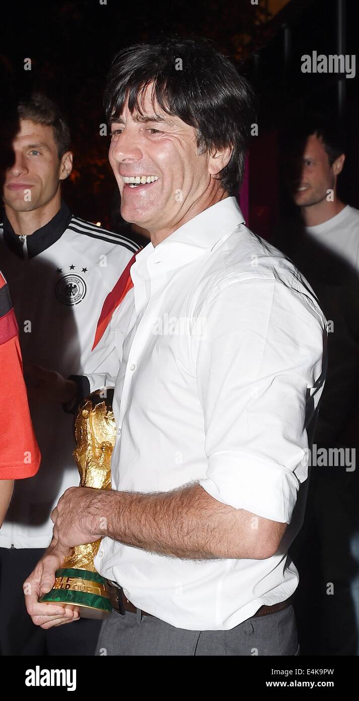 Handout: Rio de Janeiro, Brazil. 14th July, 2014. German national coach Joachim Loew celebrating Germany's victory over Argentina in the Soccer World Cup with the trophy at Hotel Sheraton in Rio De Janeiro, Brazil on 13 July 2014. Germany won the World Cup 1-0 after defeating Argentina. (: Image for in connection with the current reporting on the World Cup and together with the source: Photo: Markus Gilliar/DFB/dpa.) Credit:  dpa picture alliance/Alamy Live News Stock Photo
