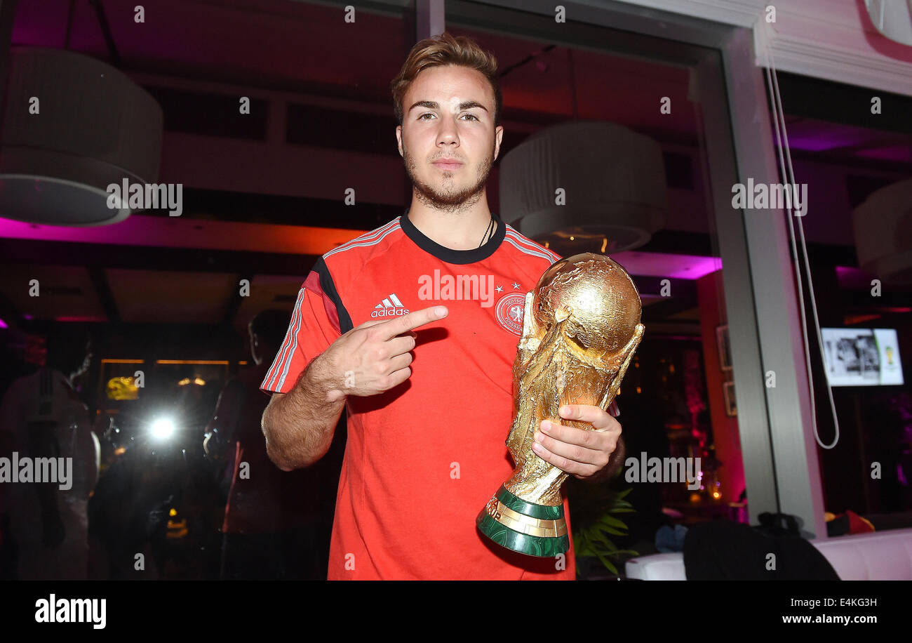 Handout: Rio de Janeiro, Brazil. 14th July, 2014. German Mario Goetze celebrating Germany's victory over Argentina in the Soccer World Cup with the trophy at Hotel Sheraton in Rio De Janeiro, Brazil on 13 July 2014. Germany won the World Cup 1-0 after defeating Argentina. (: Image for in connection with the current reporting on the World Cup and together with the source: Photo: Markus Gilliar/DFB/dpa.) Credit:  dpa picture alliance/Alamy Live News Stock Photo