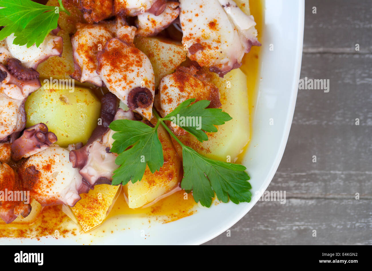 Polbo a Feira (Fair style octopus), a traditional Spanish Galician dish prepared with potatoes (cachelos), coarse salt, paprika Stock Photo