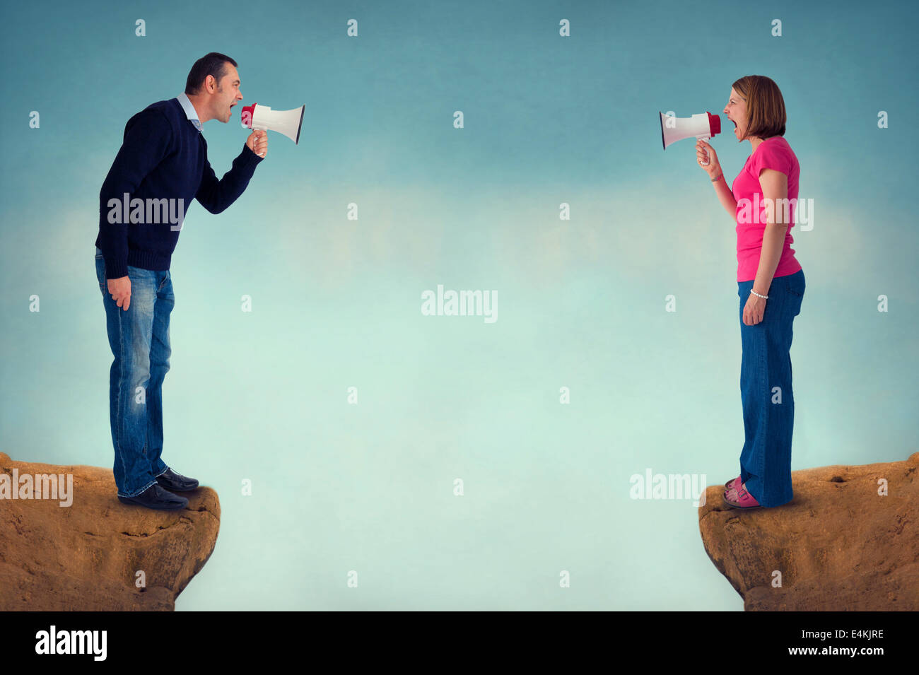 man and woman conflict concept with bullhorn and crevasse Stock Photo