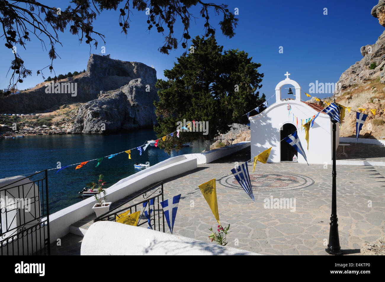 St Paul's Chapel with Lindos Acropolis in St Paul's Bay, Lindos, Rhodes ...
