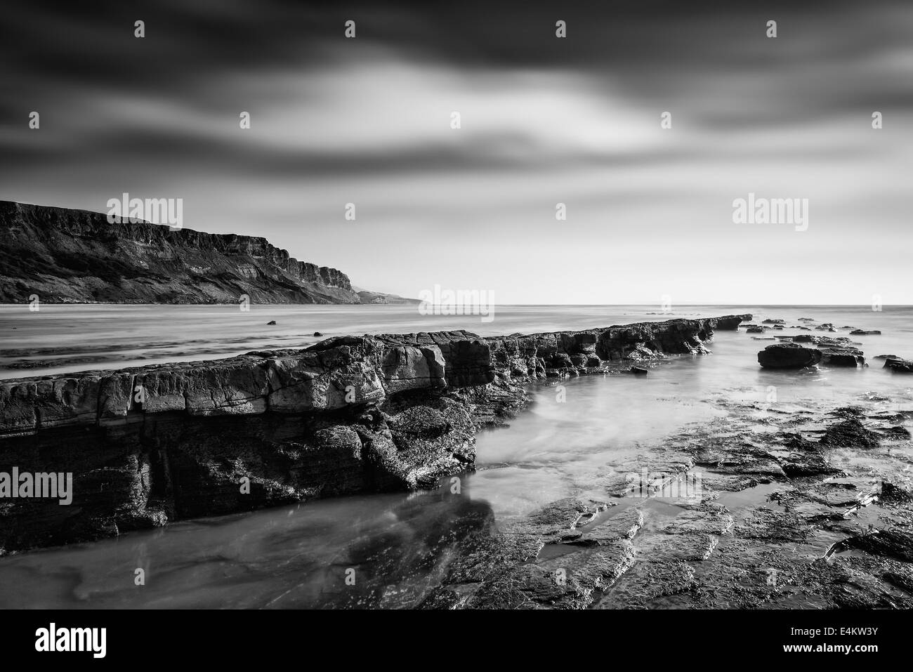 Stunning black and white seascape coastline and rocky shore at sunset ...
