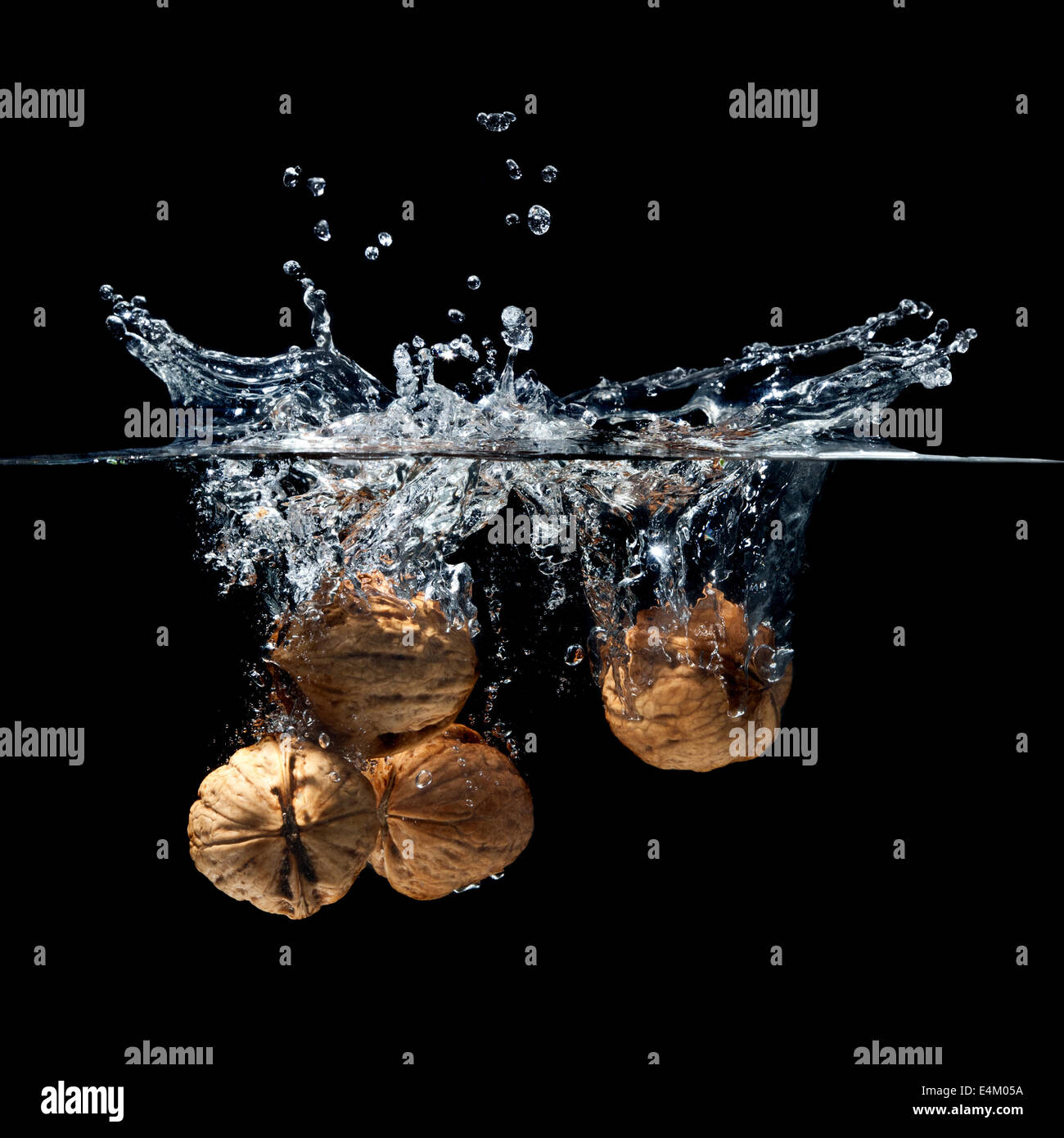 high speed photography walnuts splash in water Stock Photo