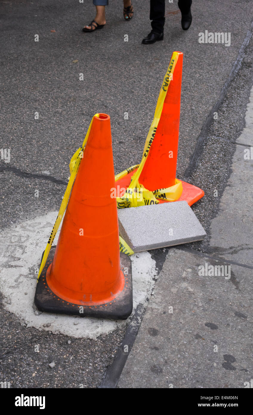 Traffic cones set up to protect repair of sidewalk in New York City