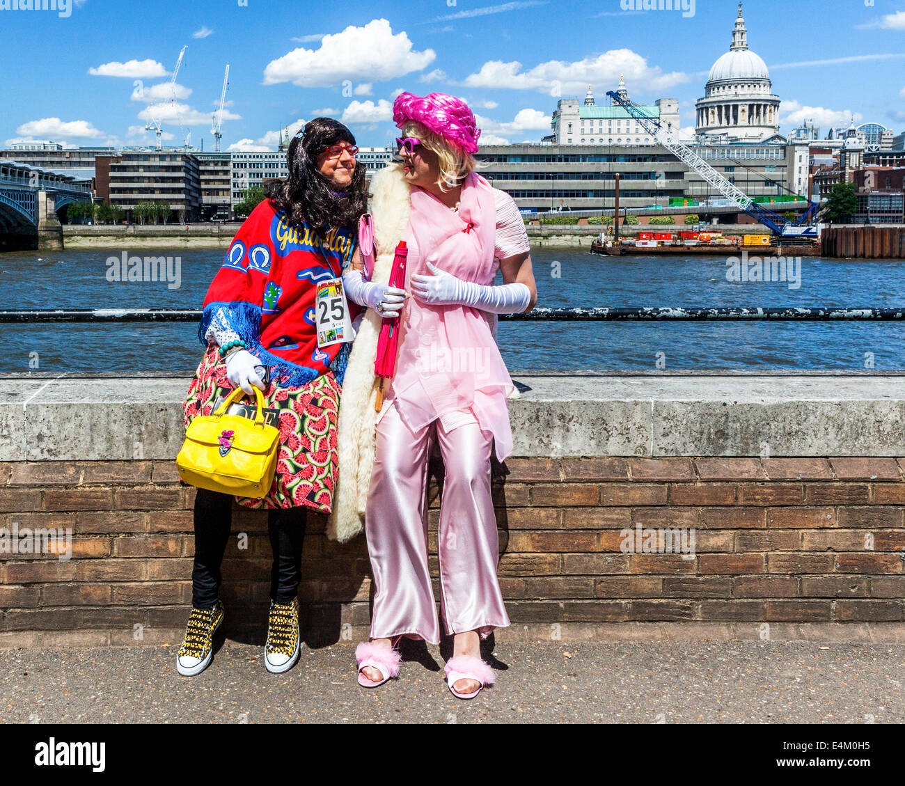 Cross dressing for 'Walk for Life 2014' - two men in woman's clothing in HIV AIDS charity race - South Bank, London, UK Stock Photo