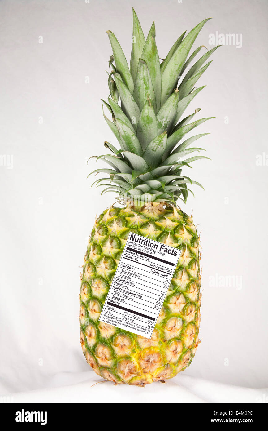 Pineapple with a nutrition fact label attached Stock Photo
