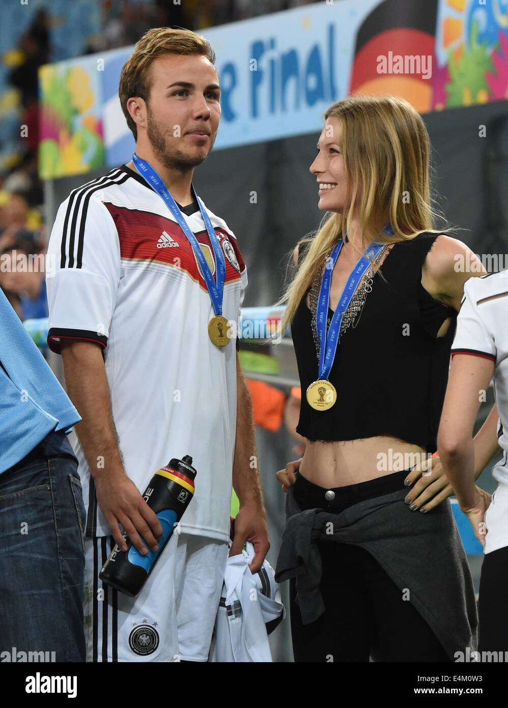 Rio de Janeiro, Brazil. 13th July, 2014. Mario Goetze and Sarah Brandner, girl friend of Bastian Schweinsteiger, after winning the FIFA World Cup 2014 final soccer match between Germany and Argentina at the Estadio do Maracana in Rio de Janeiro, Brazil, 13 July 2014. Photo: Andreas Gebert/dpa/Alamy Live News Stock Photo