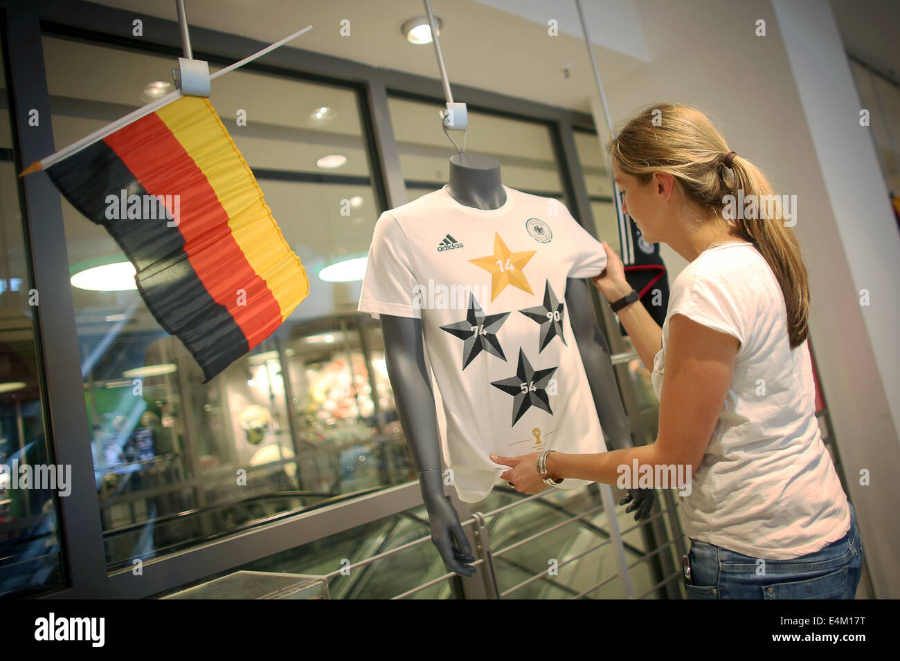 Frankfurt Main, Germany. 14th July, 2014. The new fan jersey by sports  goods manufacturer adidas is put on display by an employee at department  store 'Galeria Kaufhof' in Frankfurt Main, Germany, 14
