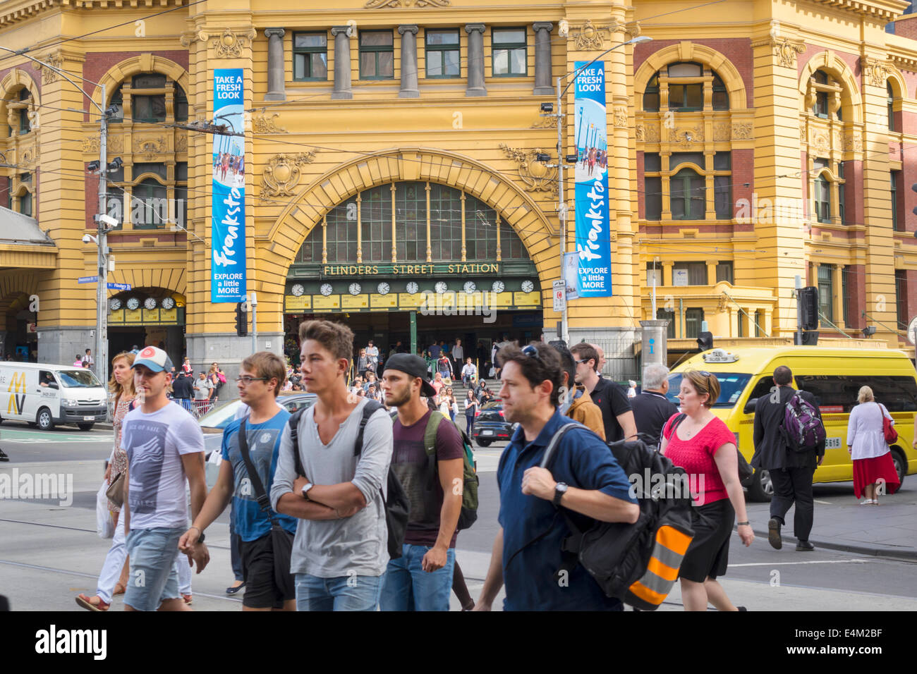 Melbourne Australia,Flinders Street Station,Metro Trains Rail Network,train,crossing intersection,man men male,woman female women,front,entrance,build Stock Photo