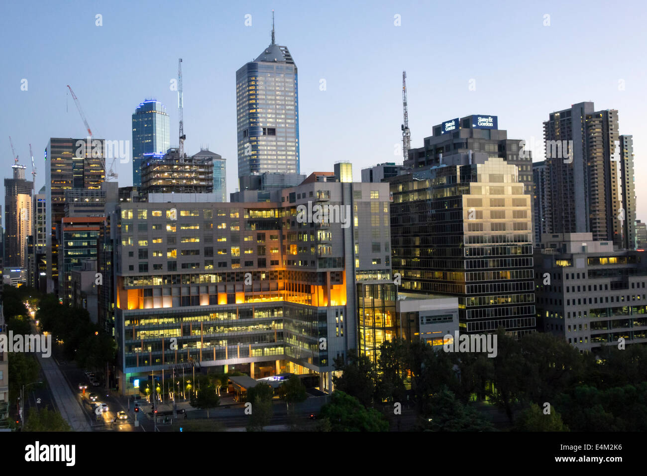 Melbourne Australia,William Street,dusk,evening,night,high rise,buildings,skyscrapers,city skyline,construction cranes,AU140318173 Stock Photo
