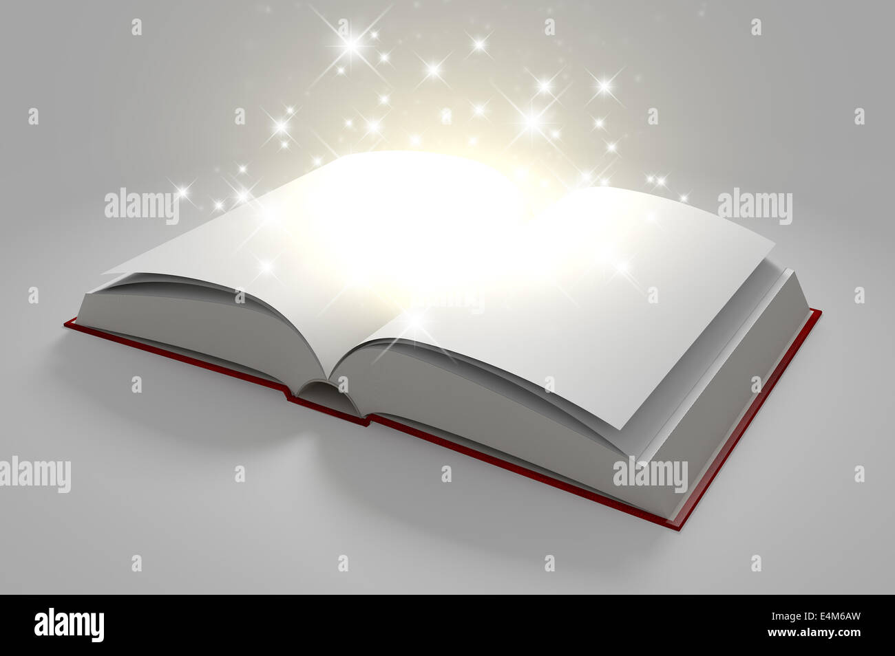 A regular hard cover book open in the middle with blank white pages that are lit by a yellow glow and magical sparkles on an iso Stock Photo