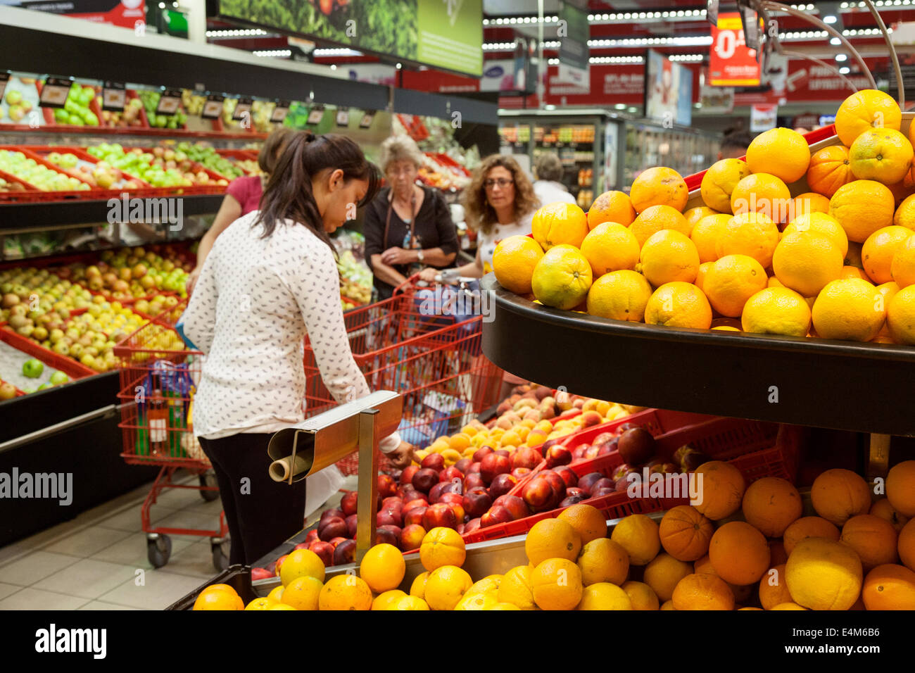 People buying food and fruit, inside a supermarket, Lagoa, Algarve, Portugal Stock Photo