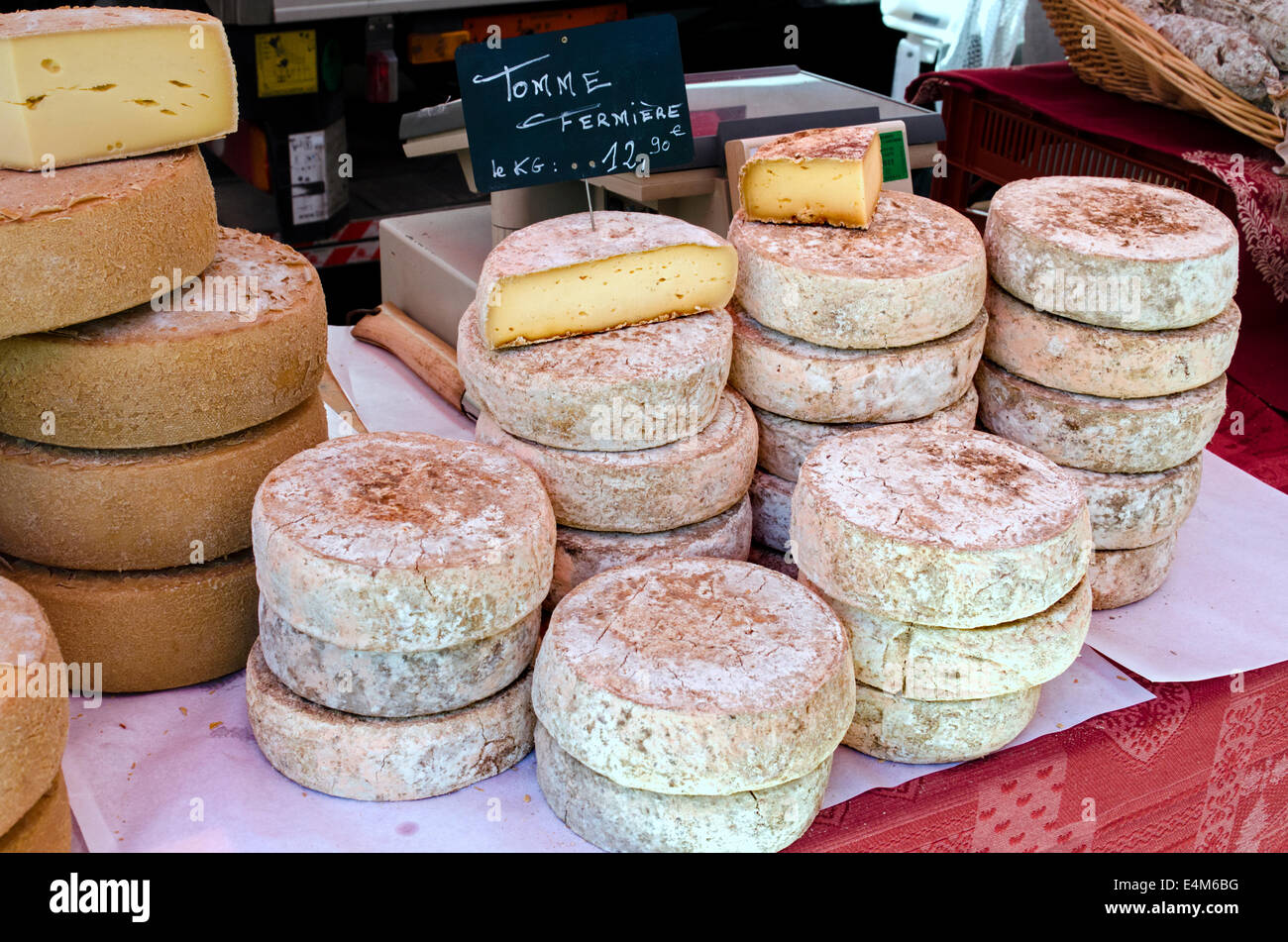 A selection of cheeses on a market stall at the Saturday market in Chamonix, Haute Savoie, France. Stock Photo