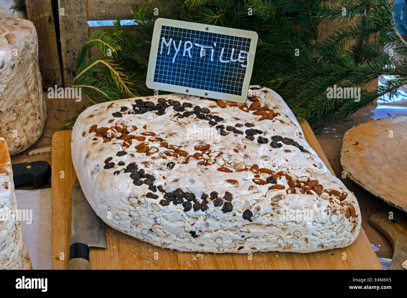 A large block of myrtle flavoured nougatine on a stall in the Saturday market in Chamonix, Haute Savoie, France. Stock Photo